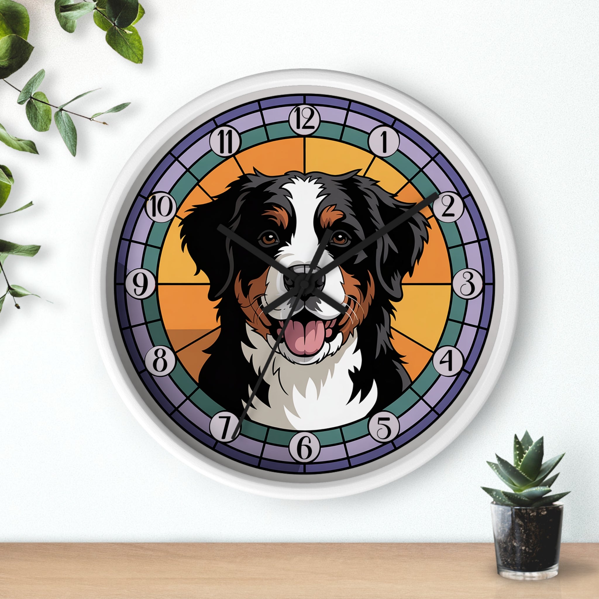 Wall clock with a dog's face design on a white wall with a plant and small pot in the background.