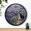 Wall clock with a painting of a Bernese mountain dog walking through a field of flowers on a white background.