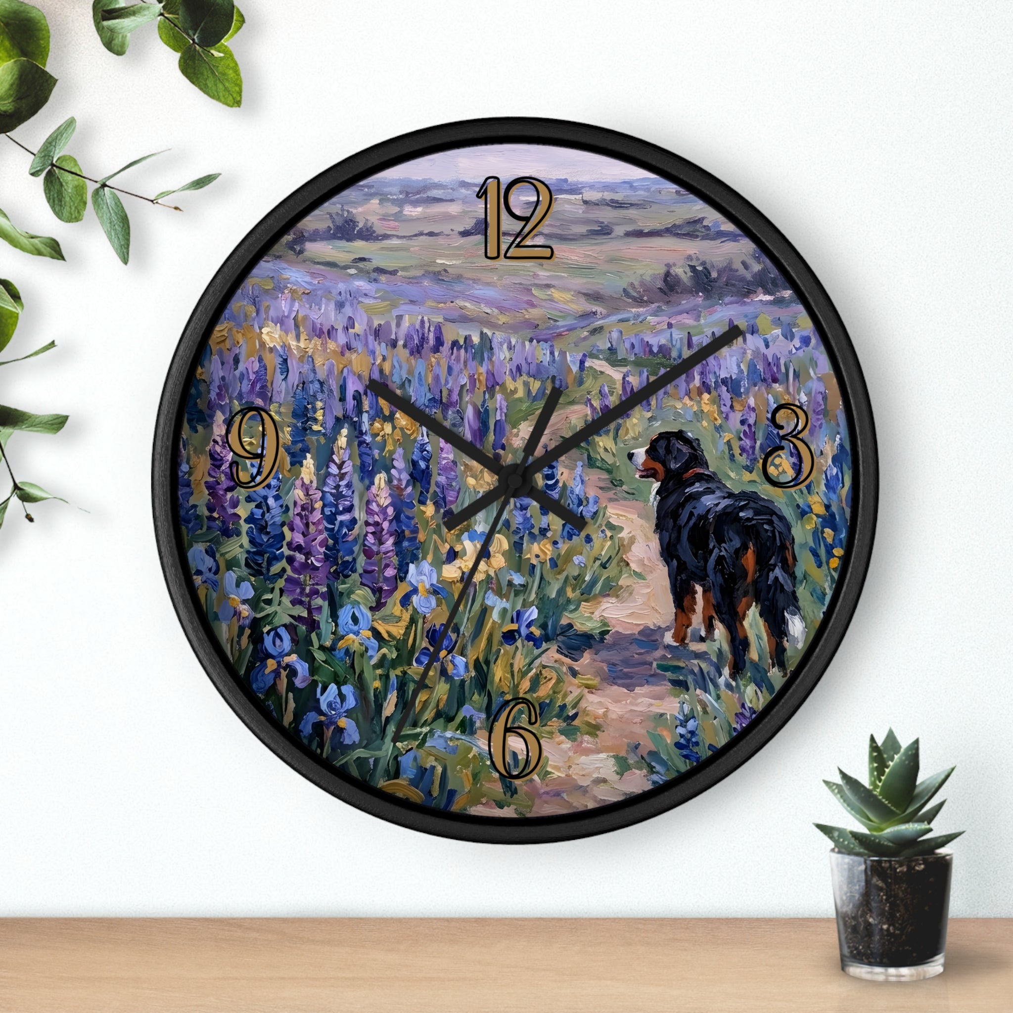 Wall clock with a painting of a Bernese mountain dog walking through a field of flowers on a white background.