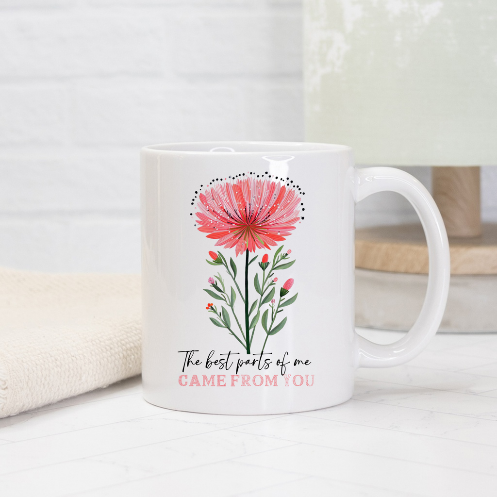 White 11oz mug with pink floral design and text on a light background