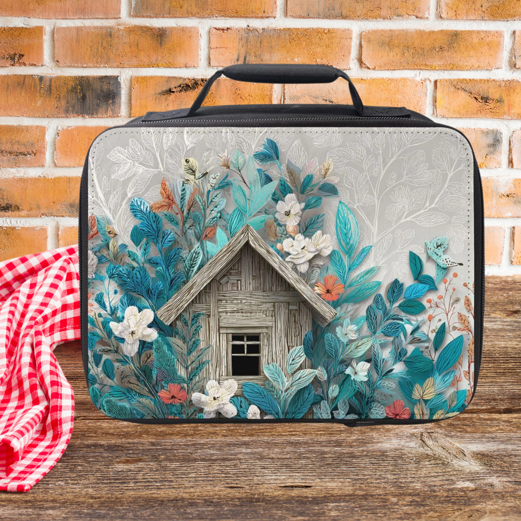 Floral and cabin design lunch bag on a wooden picnic table with a brick wall background