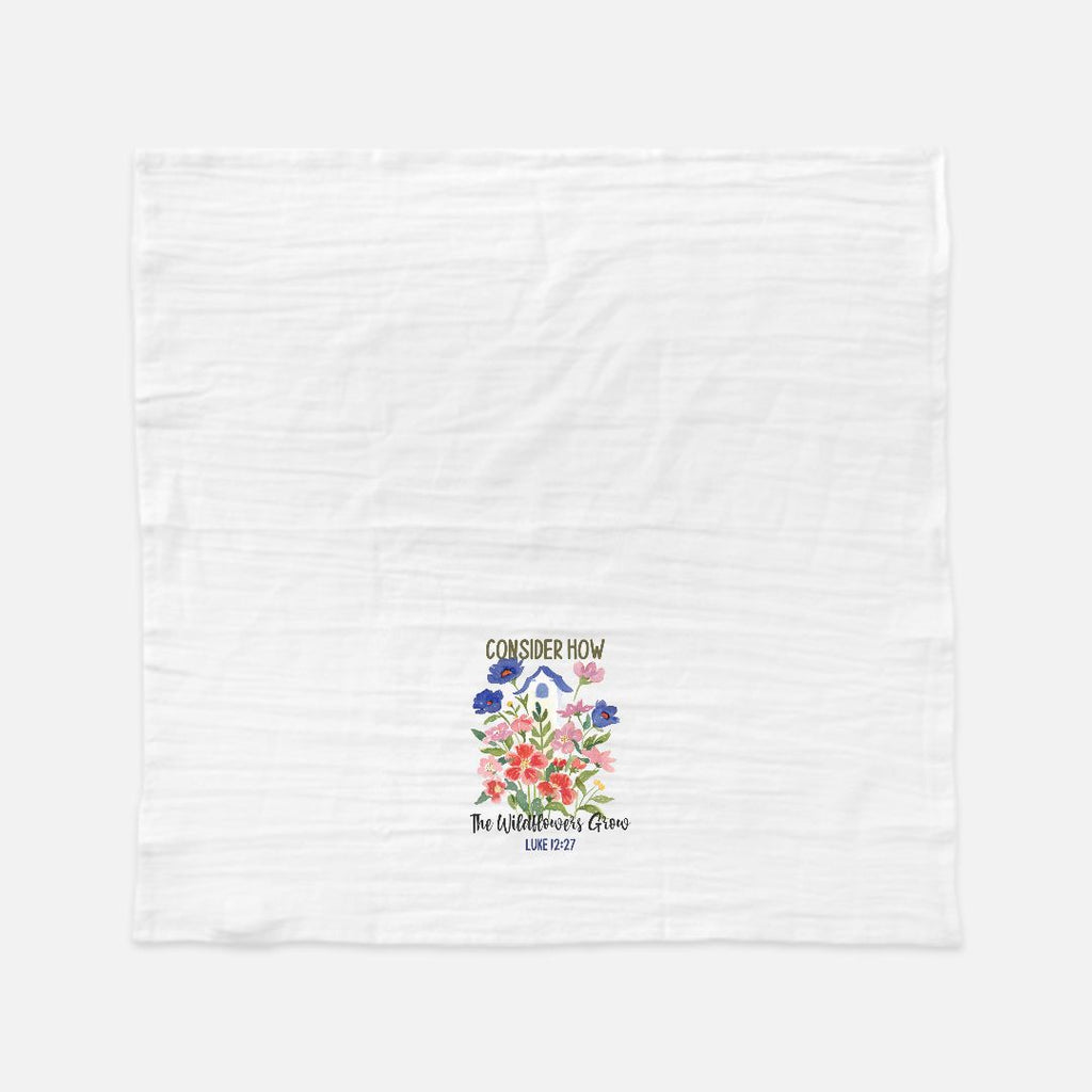White tea towel with floral design and text on a white background