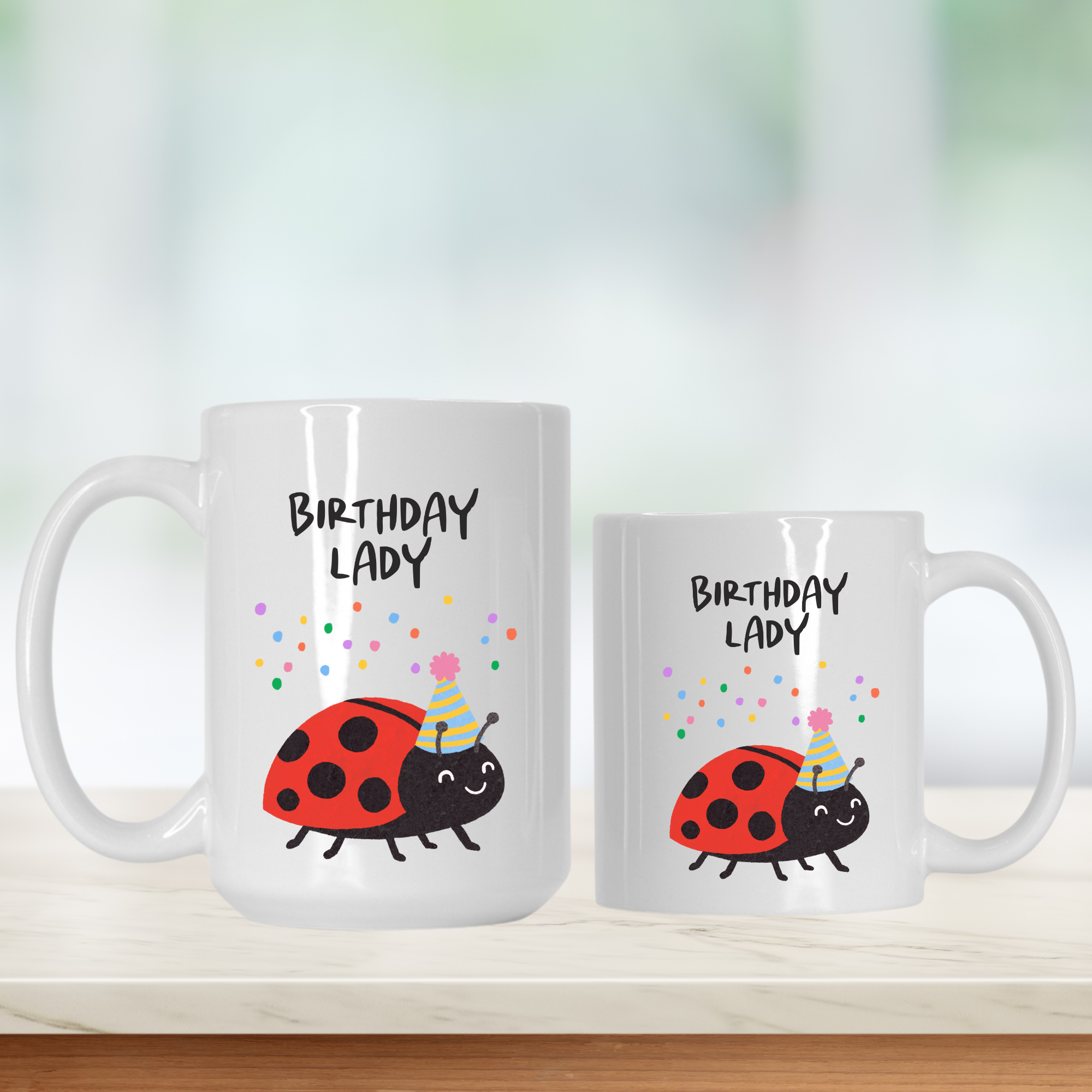 Two mugs with a ladybug design and 'Birthday Lady' text on a white background.