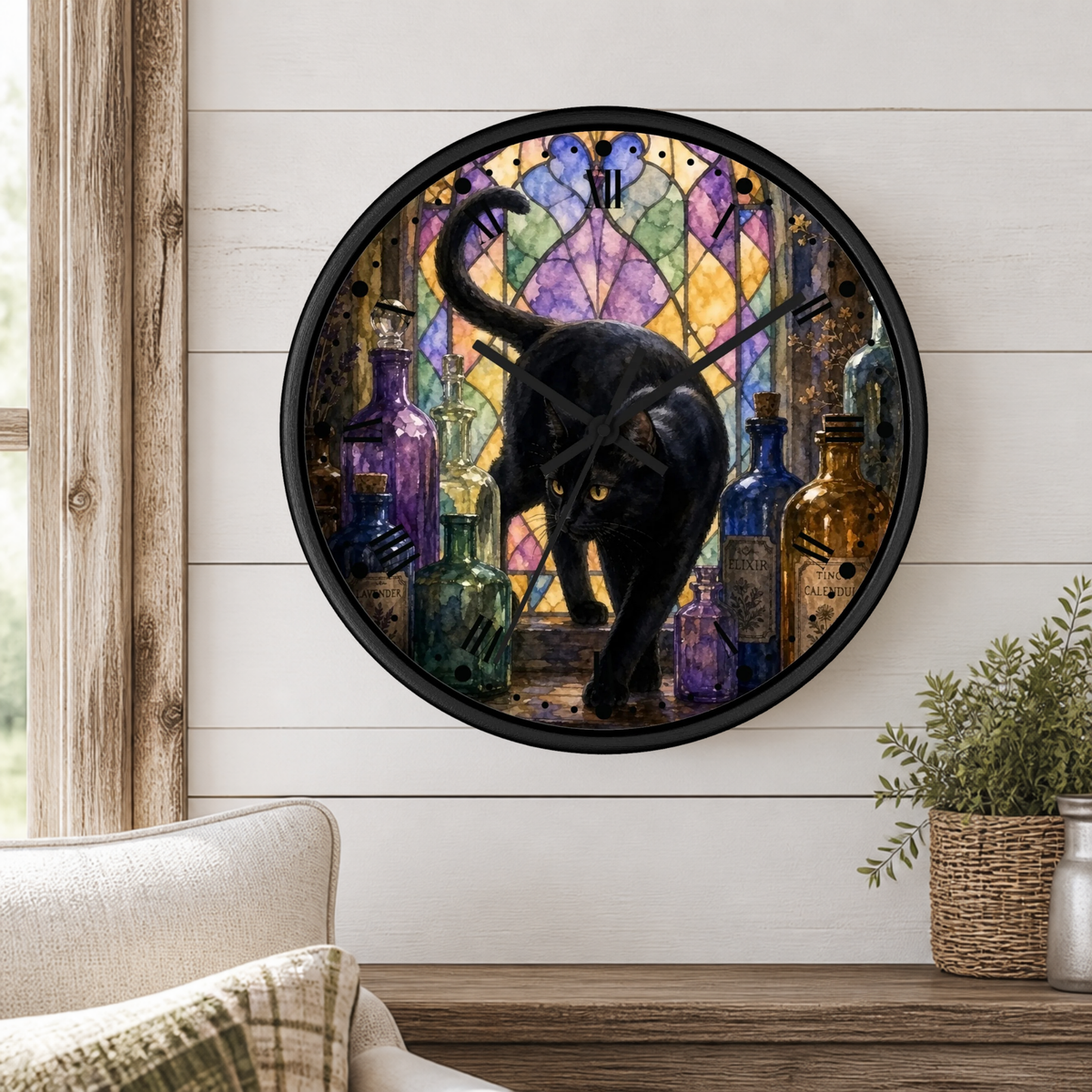 Round wall clock with a black cat walking among colorful glass bottles in front of a stained-glass-style background, mounted on a white shiplap wall above a wooden surface with a chair and plant nearby.