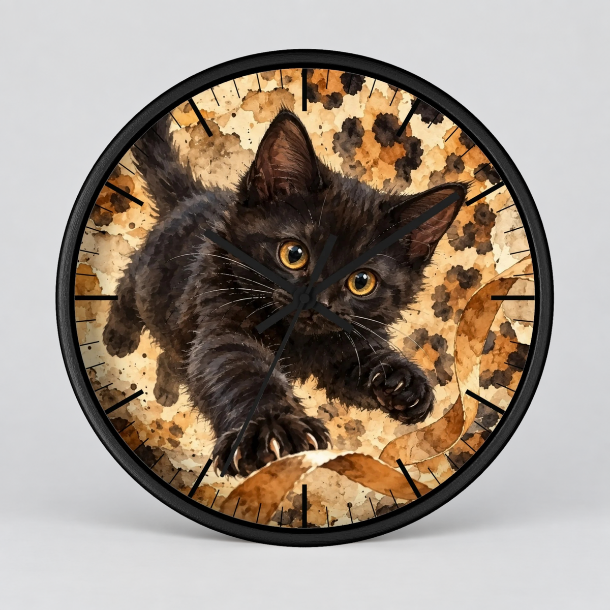 Round wall clock with a black kitten illustration on a warm brown and beige textured background, surrounded by a black frame, shown against a light gray studio background.