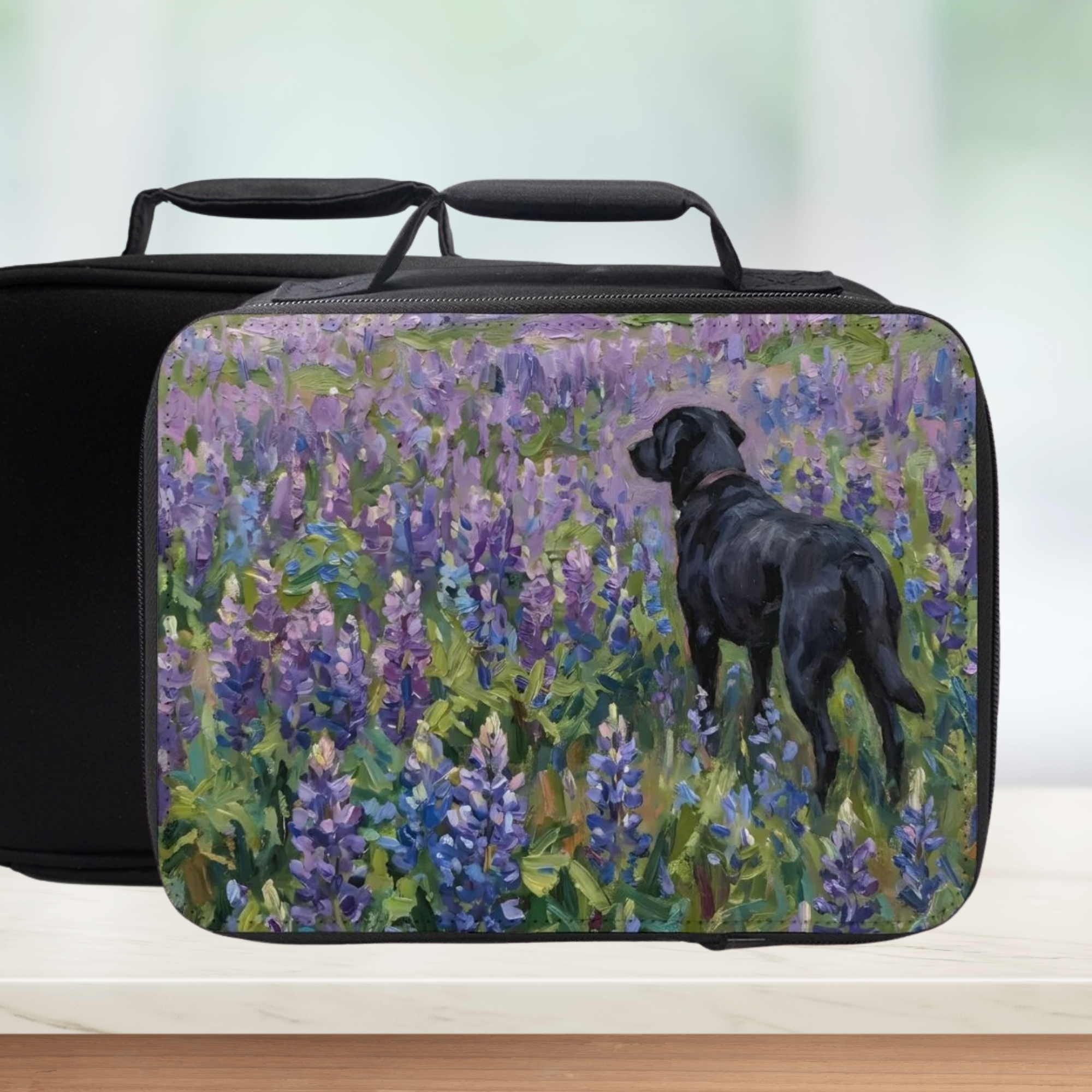 Black lunch bag with a painterly design of a black dog in a field of purple flowers on a white background