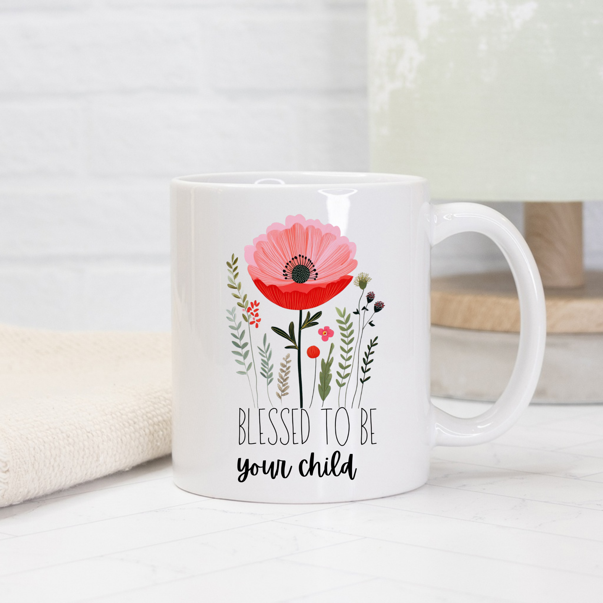 White11oz mug with floral design and text 'Blessed to be your child' on a light background