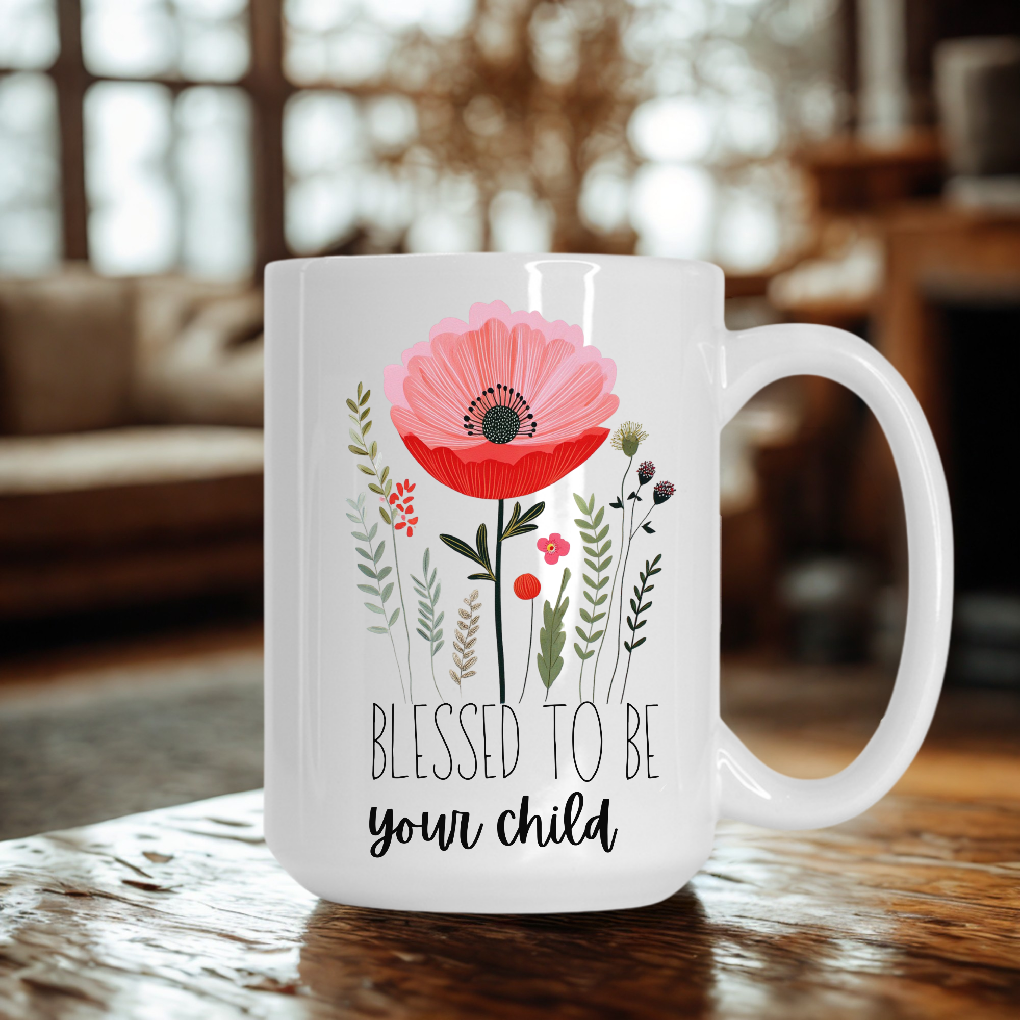 15oz white mug with floral design and text 'Blessed to be your child' on a wooden table.