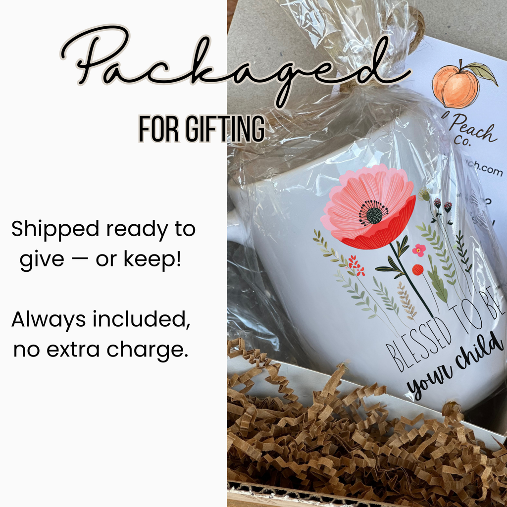 15oz white mug wrapped on clear plastic tied with twine inside a white gift box with brown shredded paper and card.
