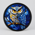 Round wall clock with a black frame and a colorful stained-glass style illustration of a blue owl perched on a branch against a starry night sky.
