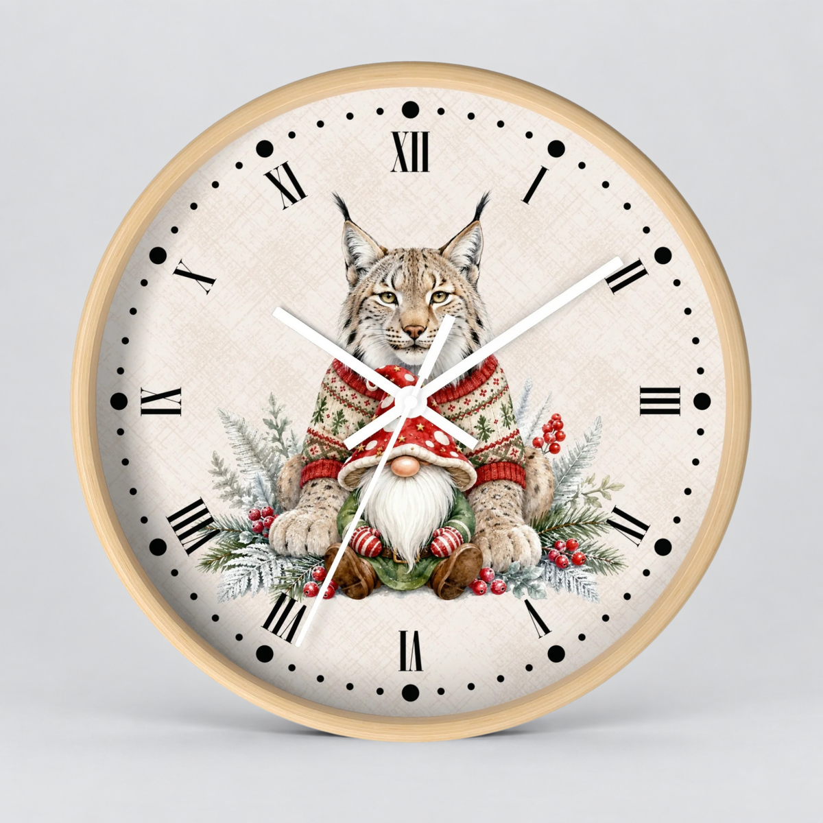 A round wall clock with a light wood frame and a cream-colored face featuring a detailed illustration of a lynx cat dressed in a red and green holiday sweater, surrounded by a gnome and winter foliage. The clock has black Roman numerals and white hands.