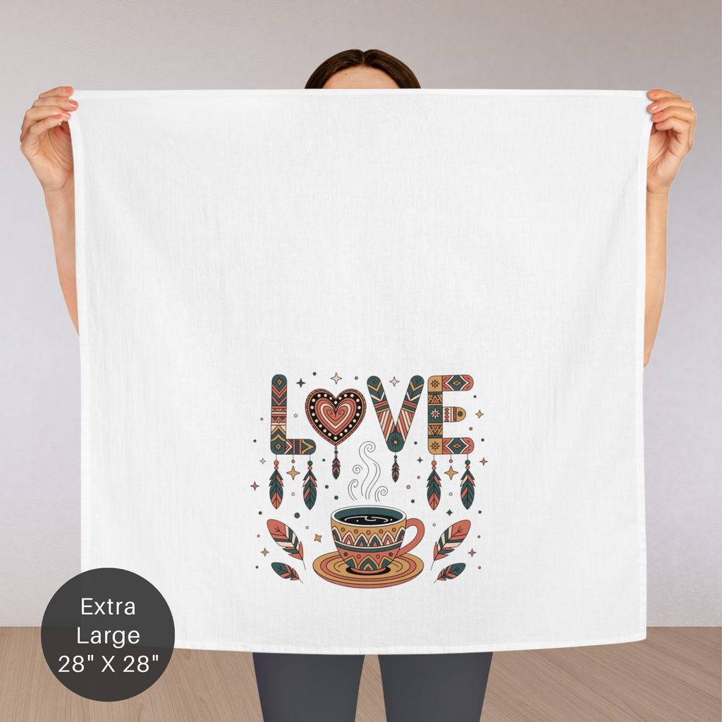 Person holding a large white towel with 'LOVE' design featuring a coffee cup and decorative elements.