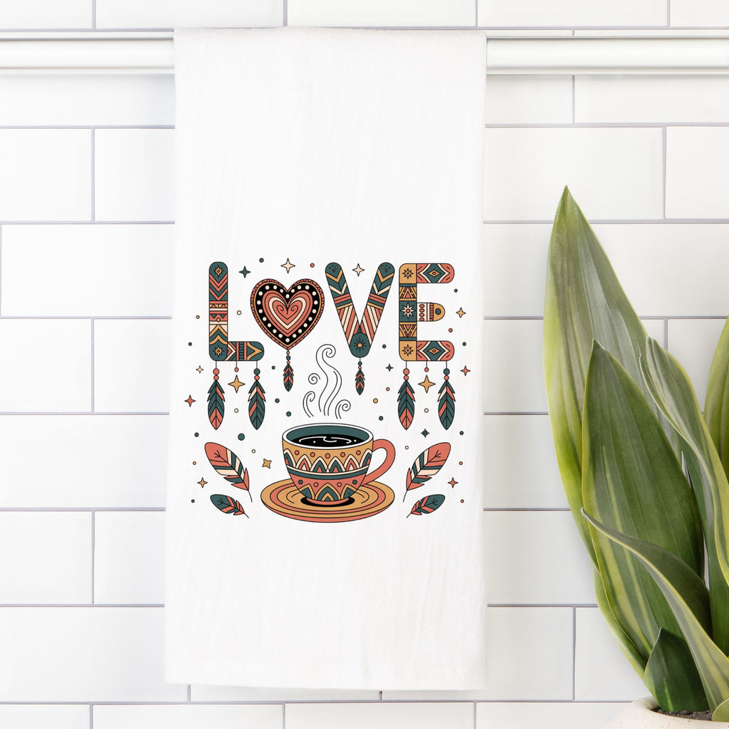 Decorative tea towel with 'LOVE' and coffee cup design on a white tiled wall.
