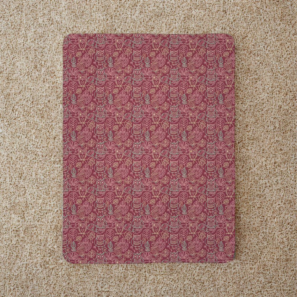 Red patterned blanket on a beige carpet