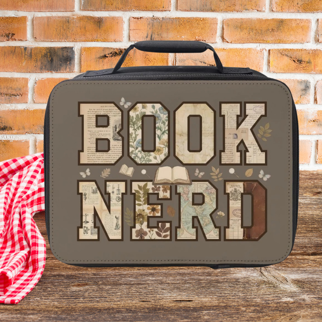 Lunch bag with 'BOOK NERD' text on a wooden picnic table against a brick wall background