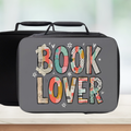 Lunch bag with 'Book Lover' patterned text on a blurred background