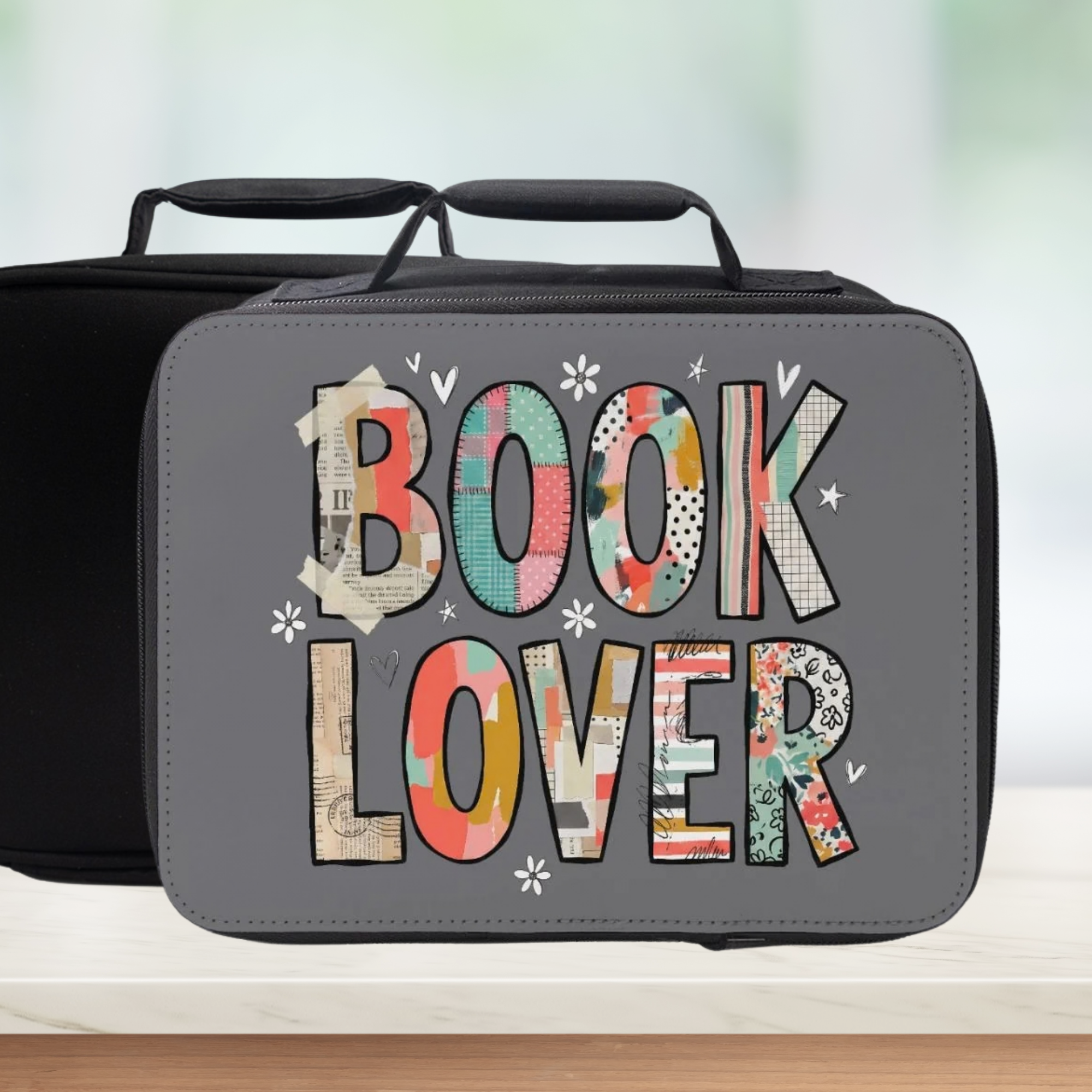 Lunch bag with 'Book Lover' patterned text on a blurred background
