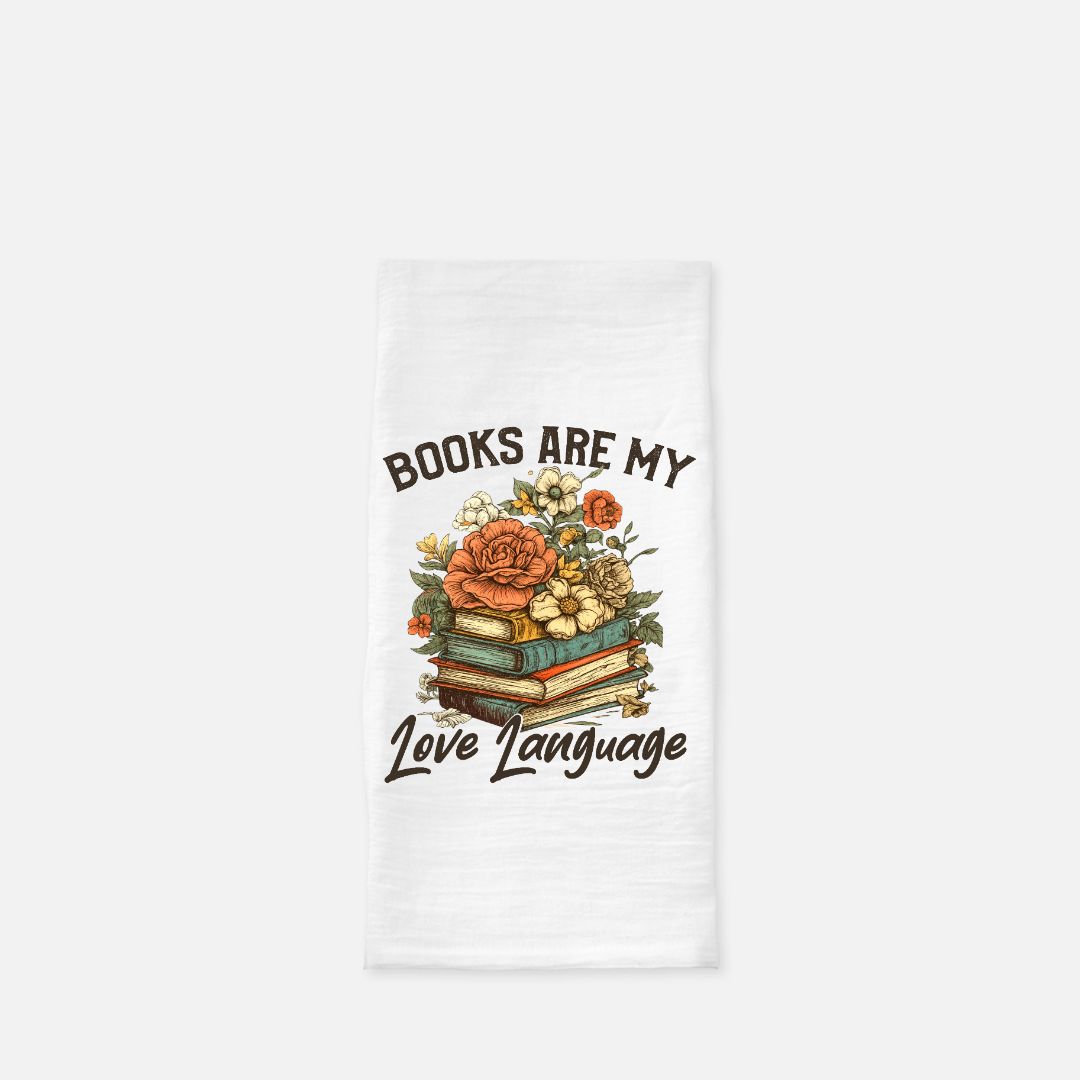 Tea towel with floral design and text 'Books are my love language' on a white background