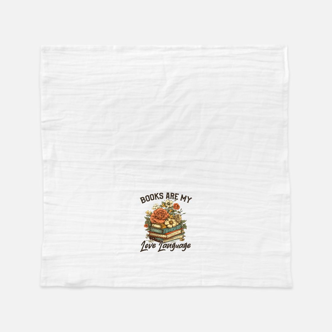 White tea towel with a graphic design of books and flowers, text 'Books are my love language', on a white background.