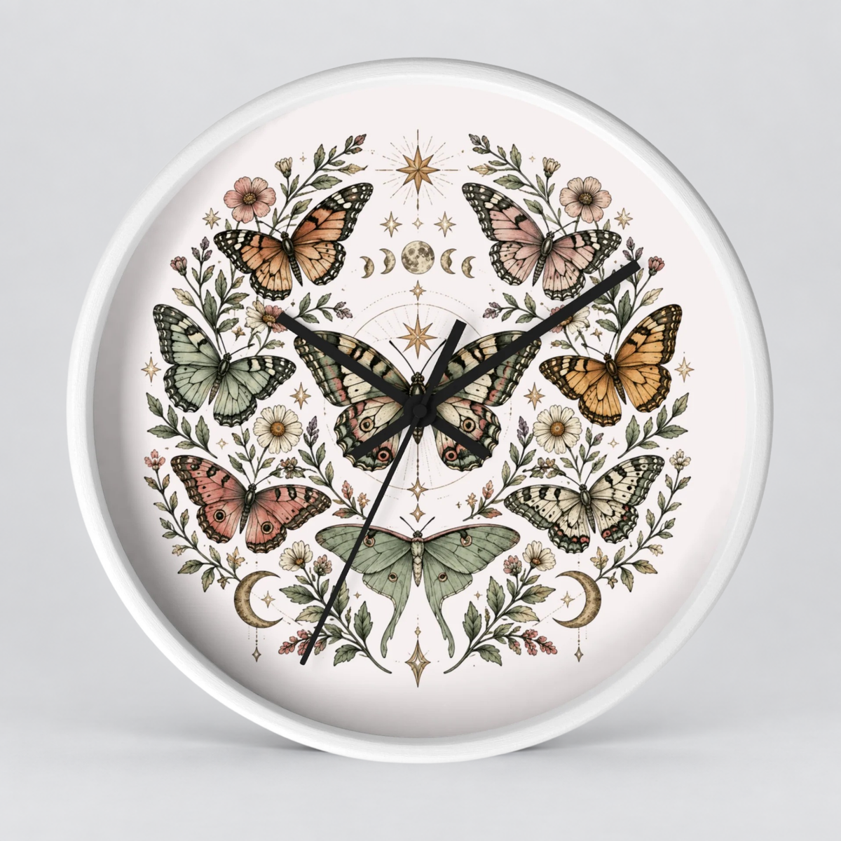 Round wall clock with a white frame and a detailed botanical illustration on the face, featuring multiple butterflies, flowers, leaves, stars, and moon phases in muted earthy tones against a light background.