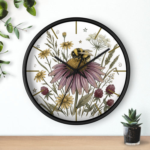 Round black decorative wall clock with a hand drawn bee and flower design on a white background