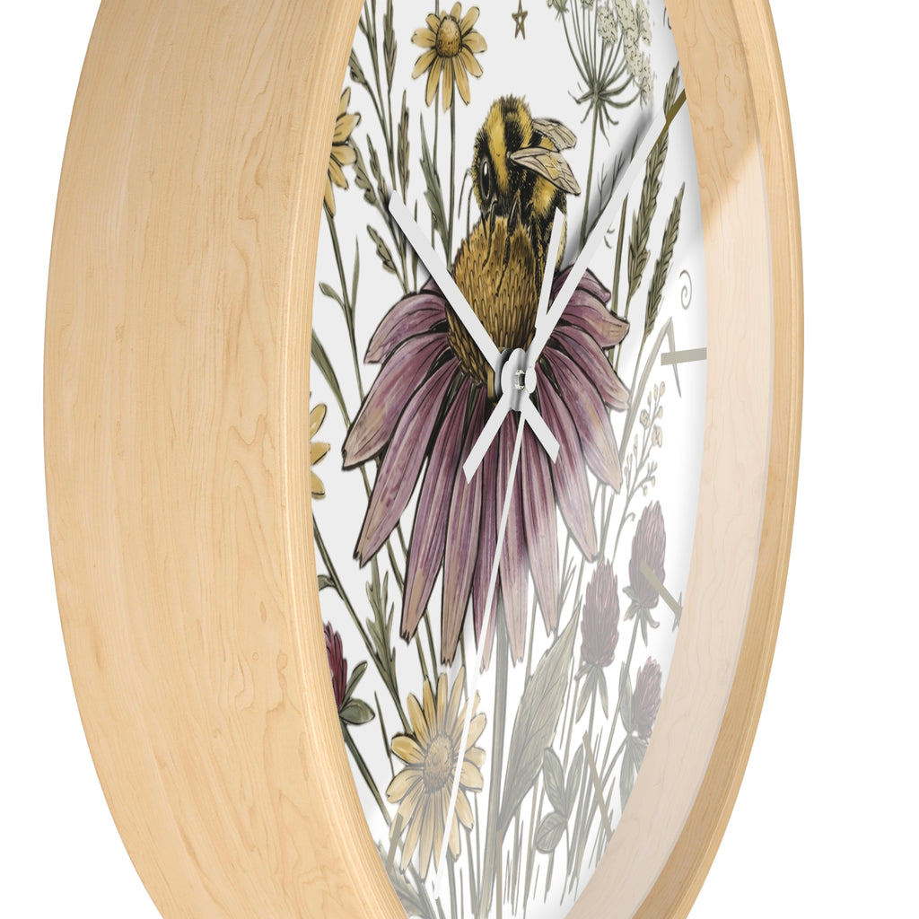 Side view of a round wood decorative wall clock with floral and bee design on a white background