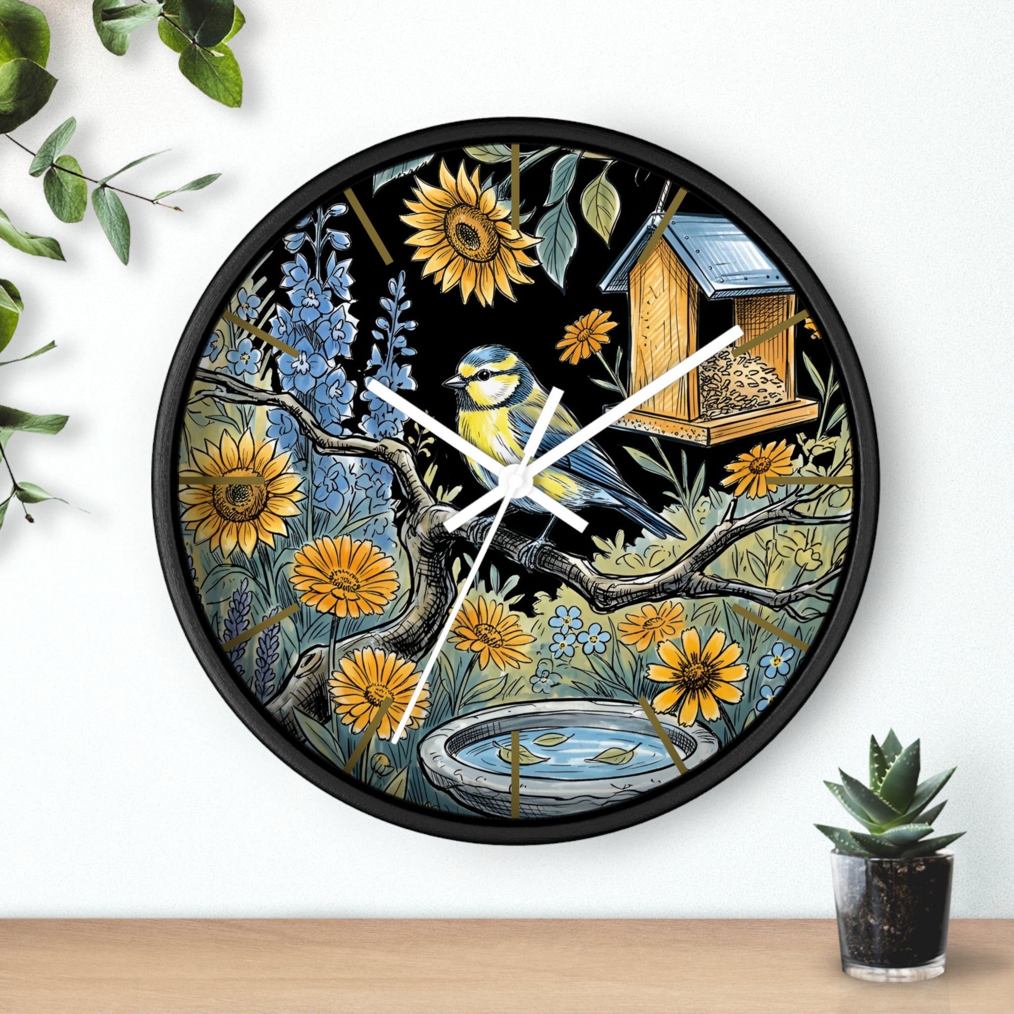 Black round decorative wall clock with white hands and  nature-themed design featuring a bird, flowers, and a birdhouse.