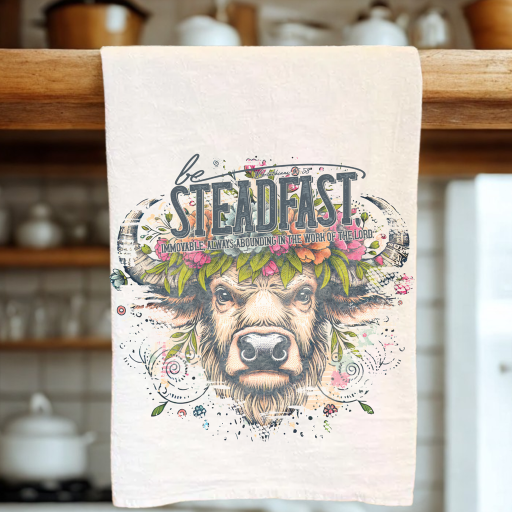 Teal towel with a buffalo illustration and motivational text on a kitchen towel rack.