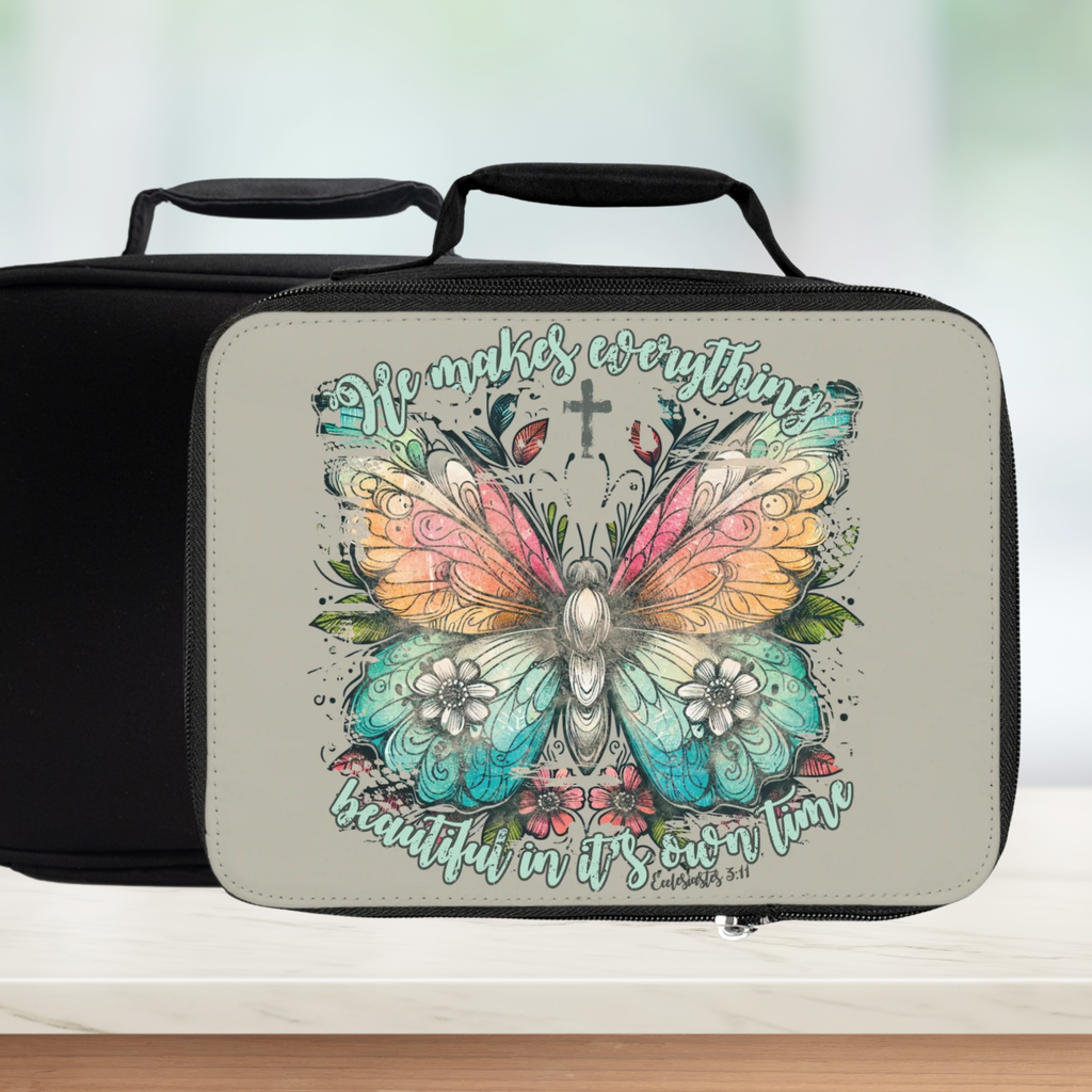  insulated lunch bag with butterfly design and text on a wooden surface