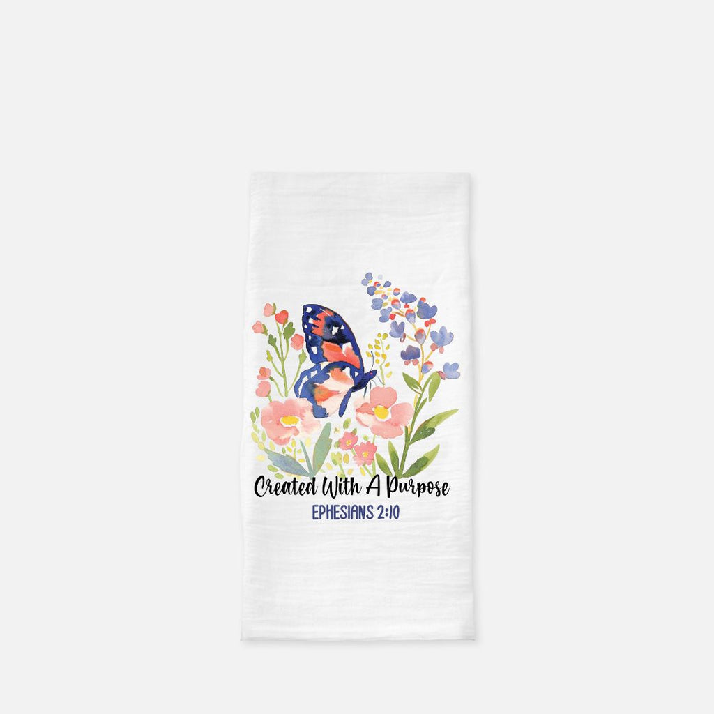 Tea towel with floral design of a butterfly and scripture text 'Created With A Purpose, Ephesians 2:10' on a white background