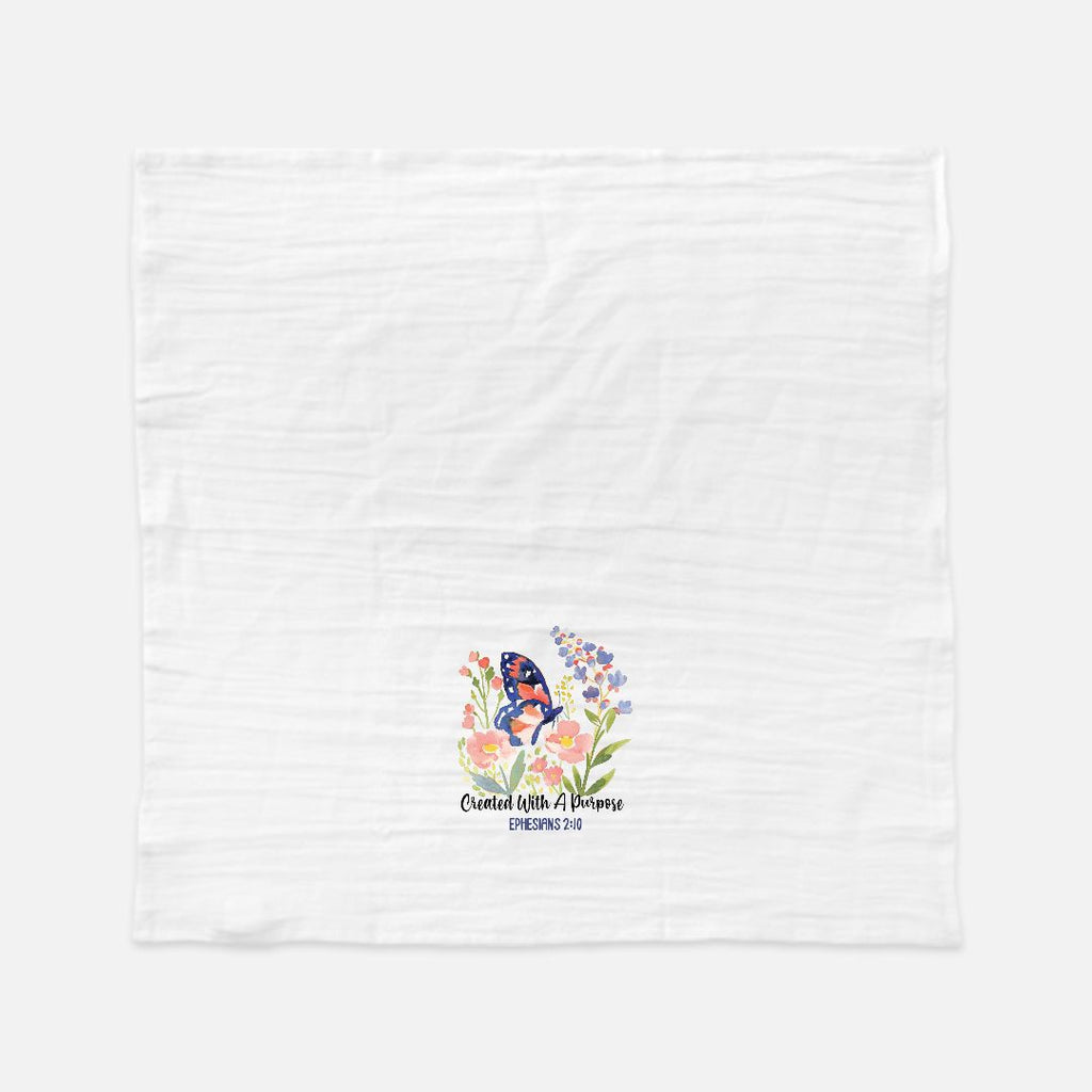 White tea towel with floral design and butterfly on a white background