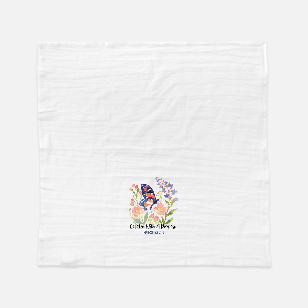 White tea towel with floral design and butterfly on a white background