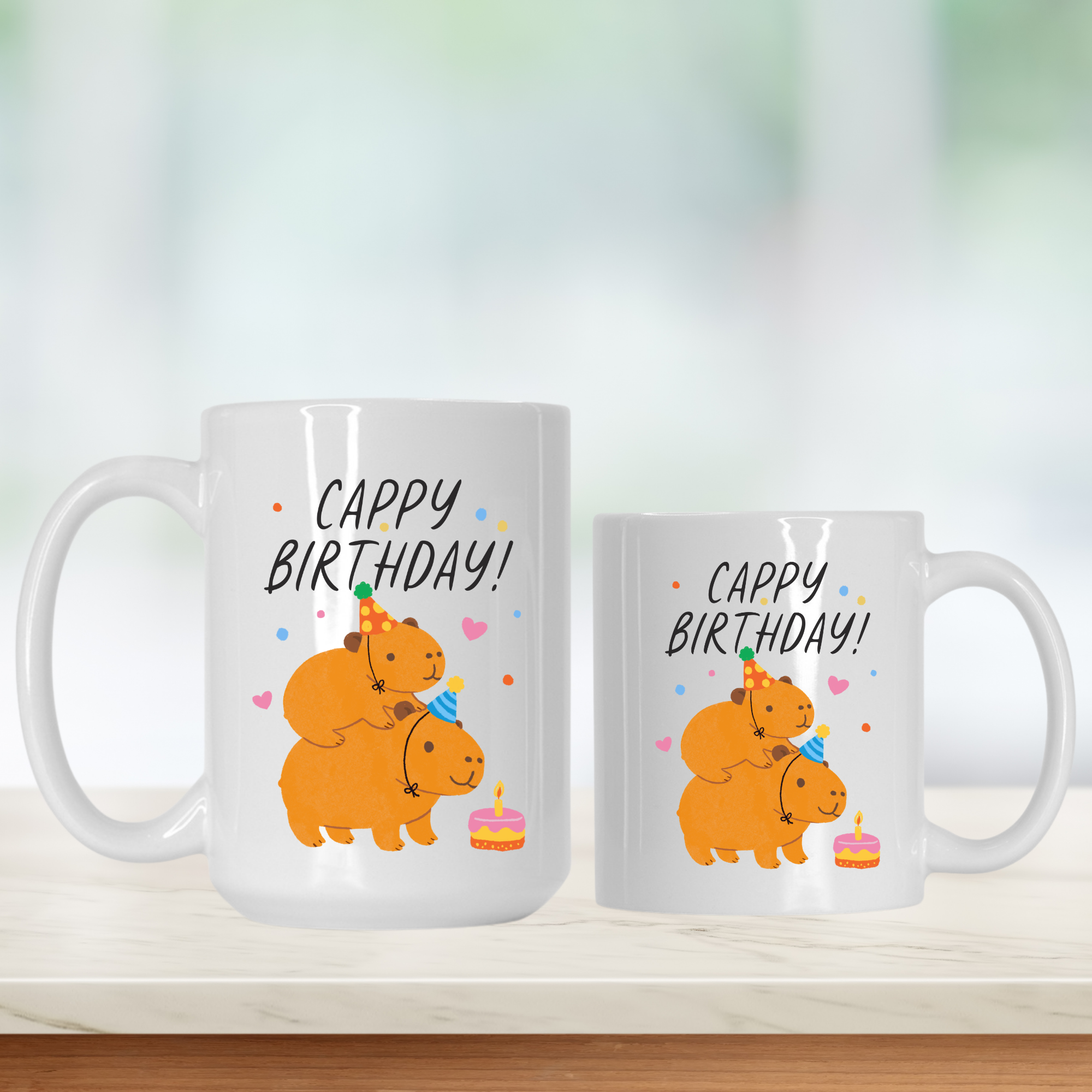 Two mugs with cartoon Capybaras and 'Cappy Birthday!' text on a white background