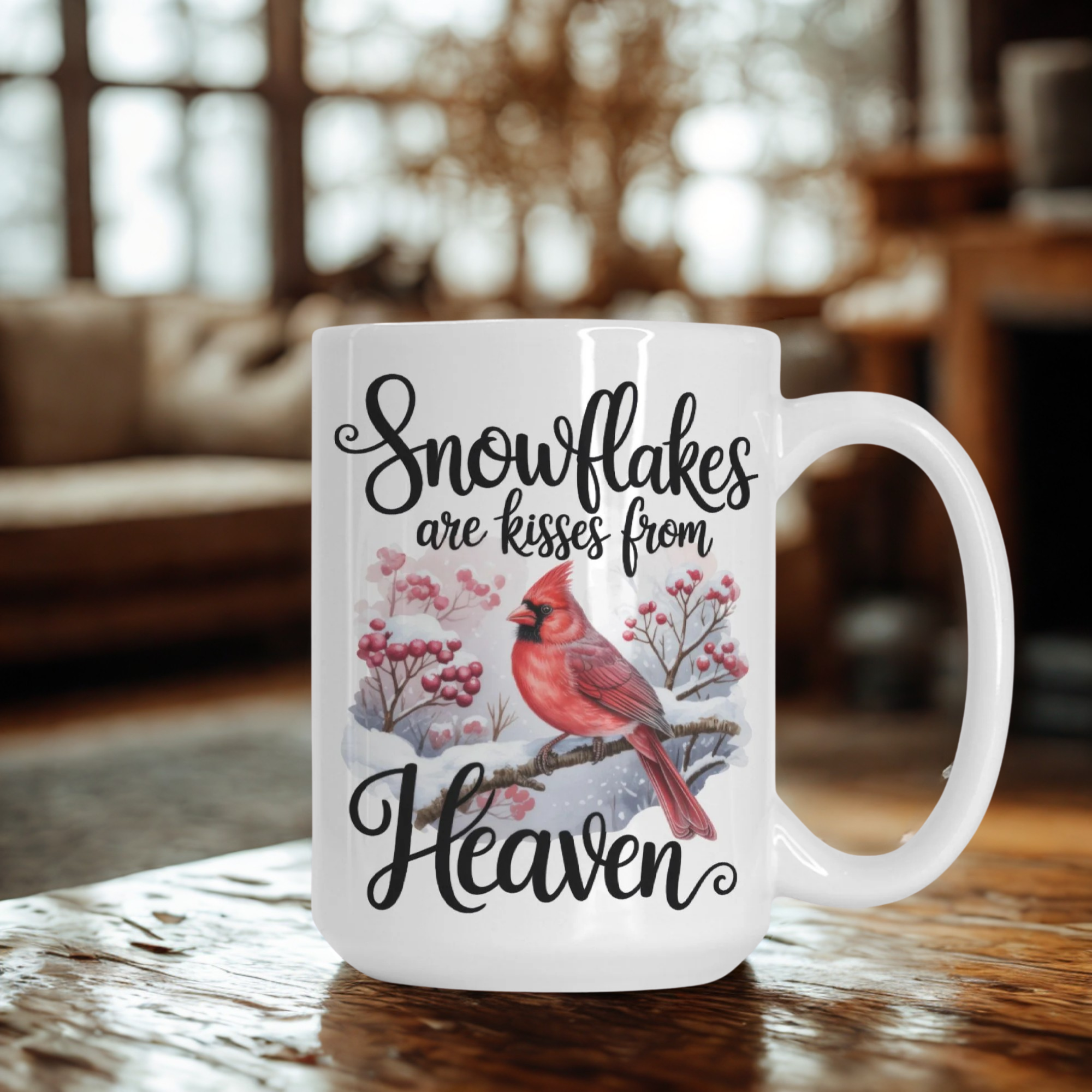 White mug with a red cardinal design and text on a wooden table.