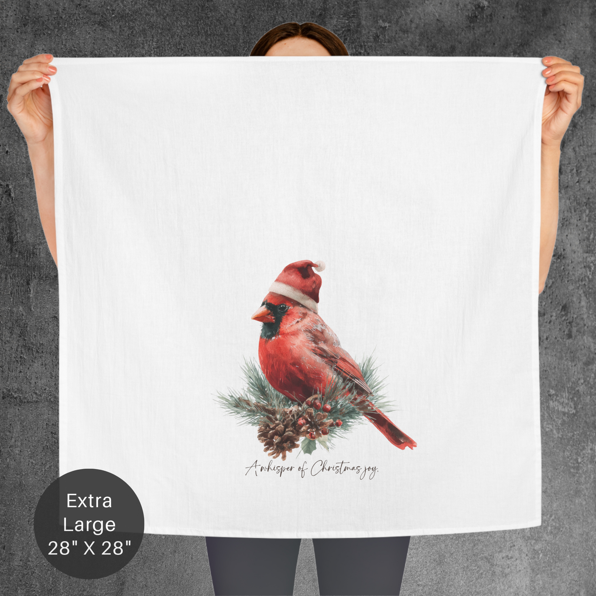 Person holding a towel with a red cardinal design and text on a gray background