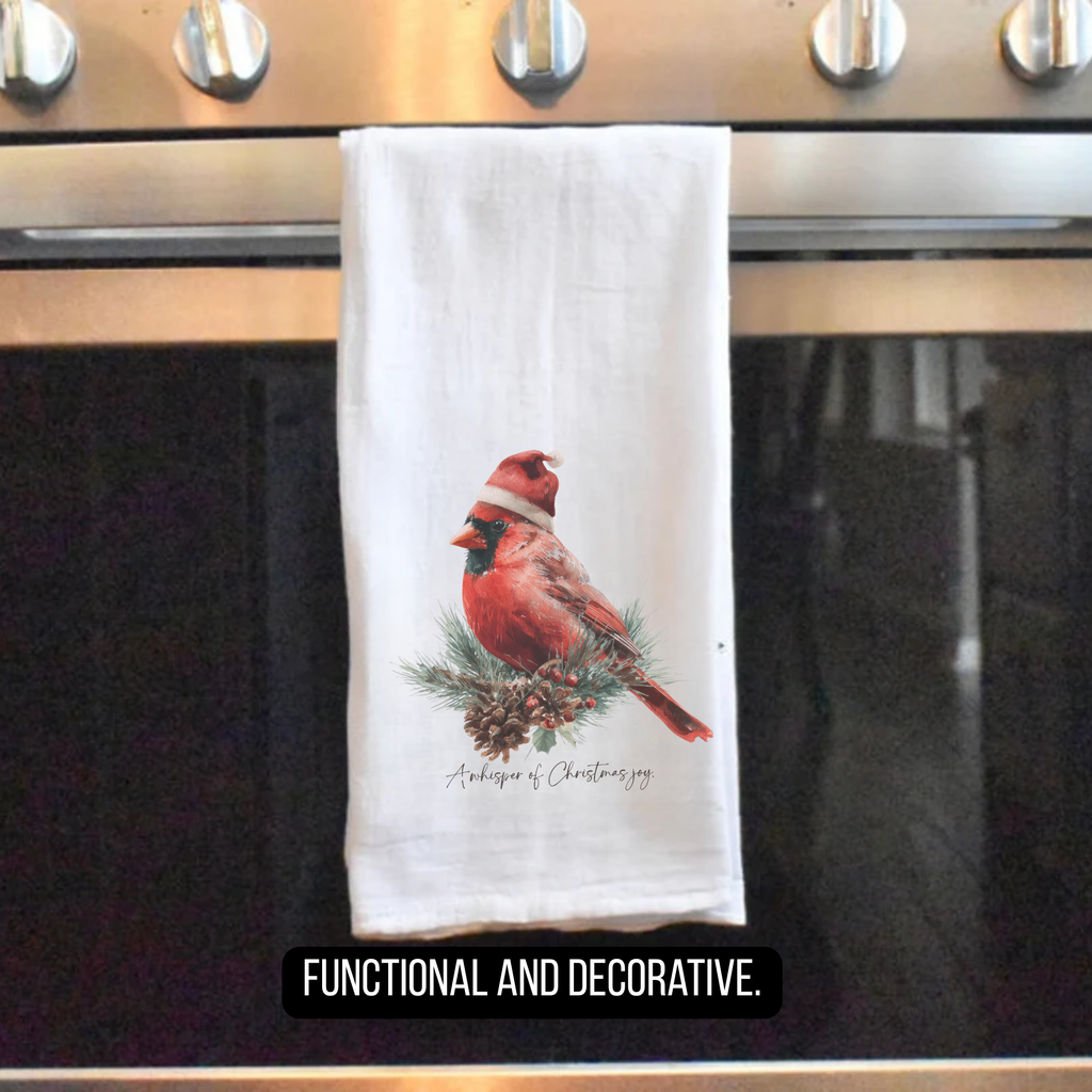 Tea towel with cardinal design hanging on a stove handle