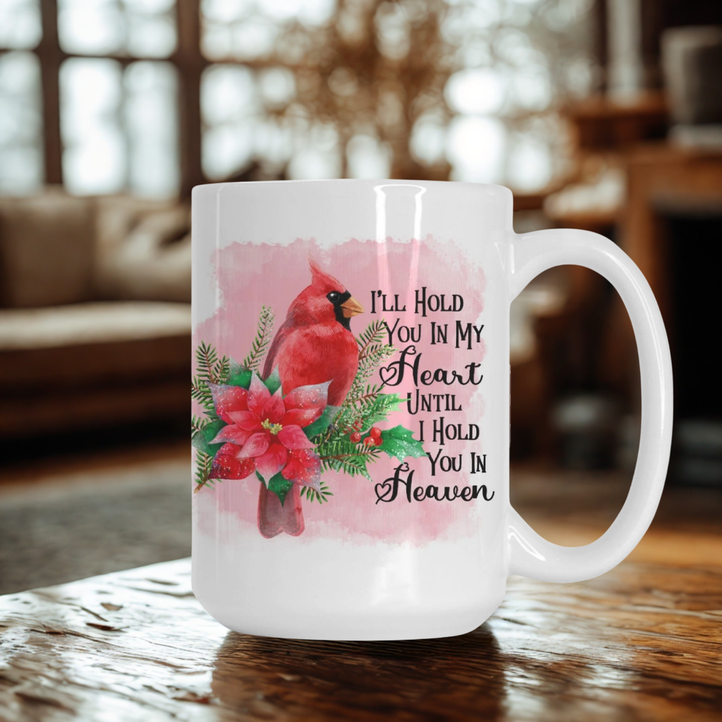 Mug with a red cardinal and floral design on a wooden table.