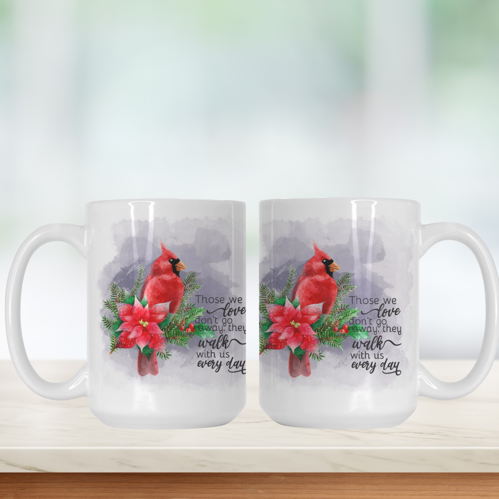 Two white mugs with cardinal birds and poinsettias on a white background