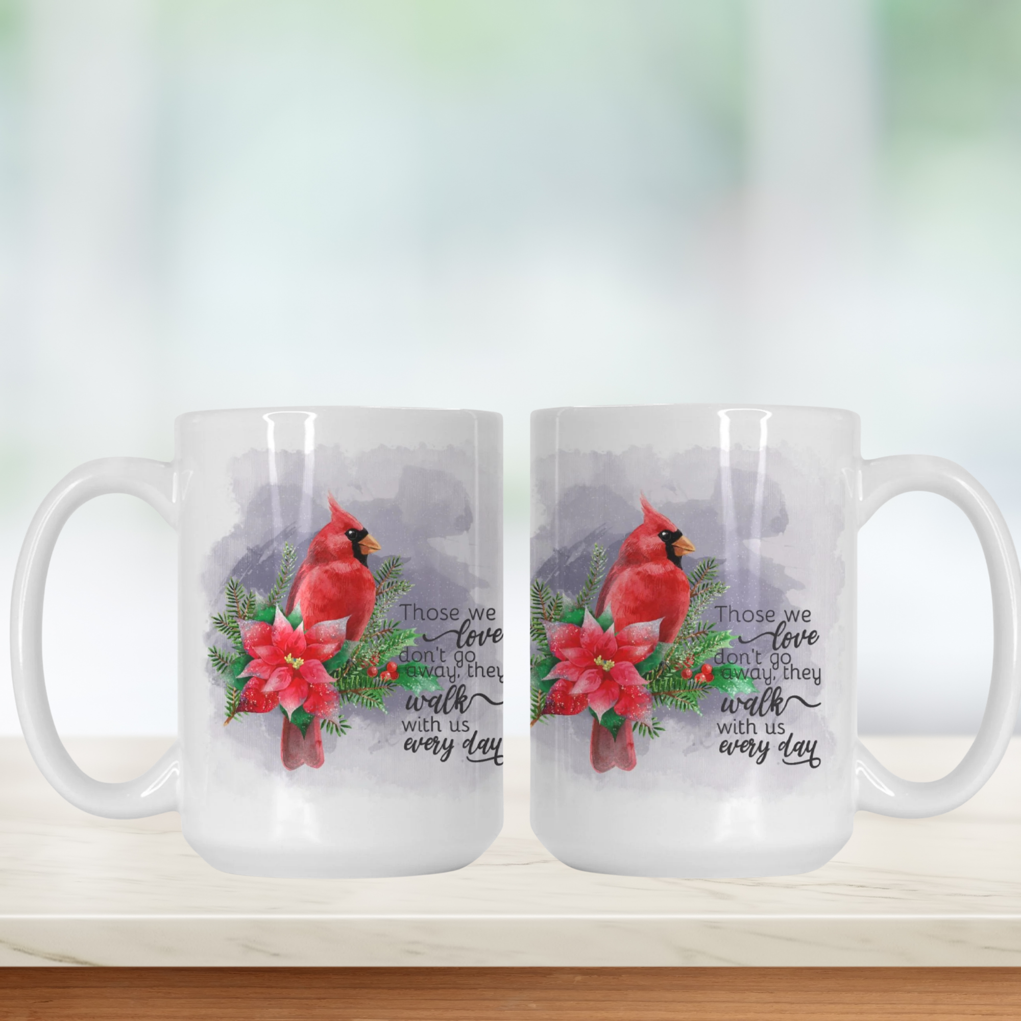 Two white mugs with cardinal birds and poinsettias on a white background