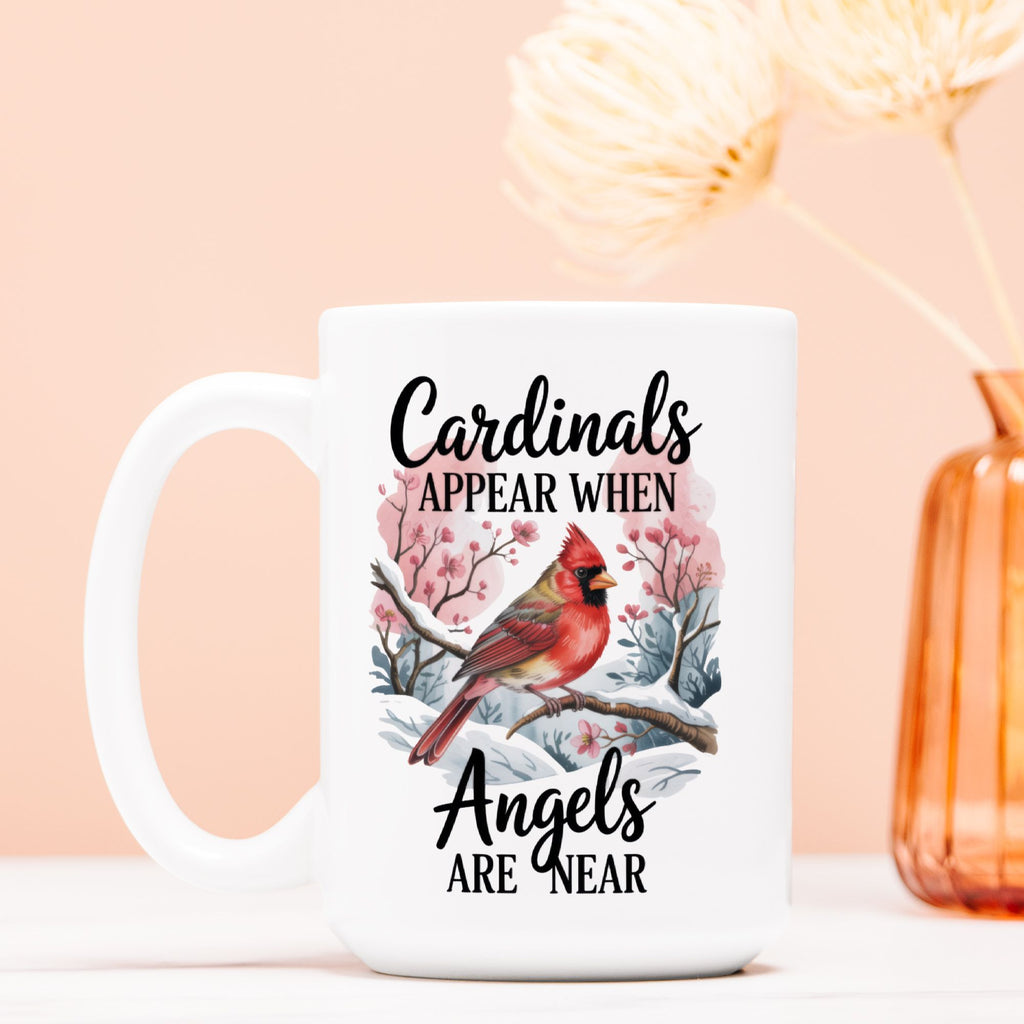 White mug with cardinal design and text on a light pink background