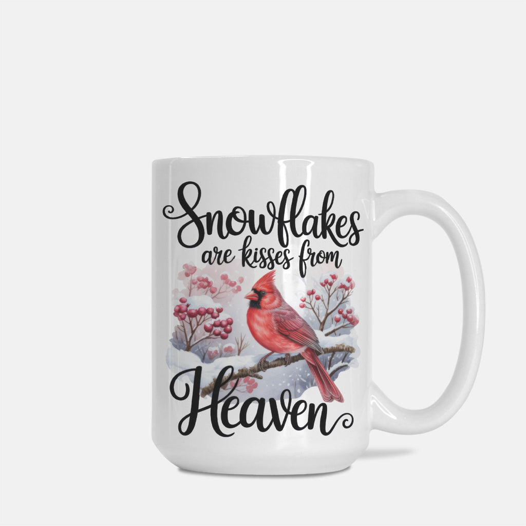 White mug with a red cardinal and snowflake design, featuring text 'Snowflakes are kisses from Heaven' on a white background.