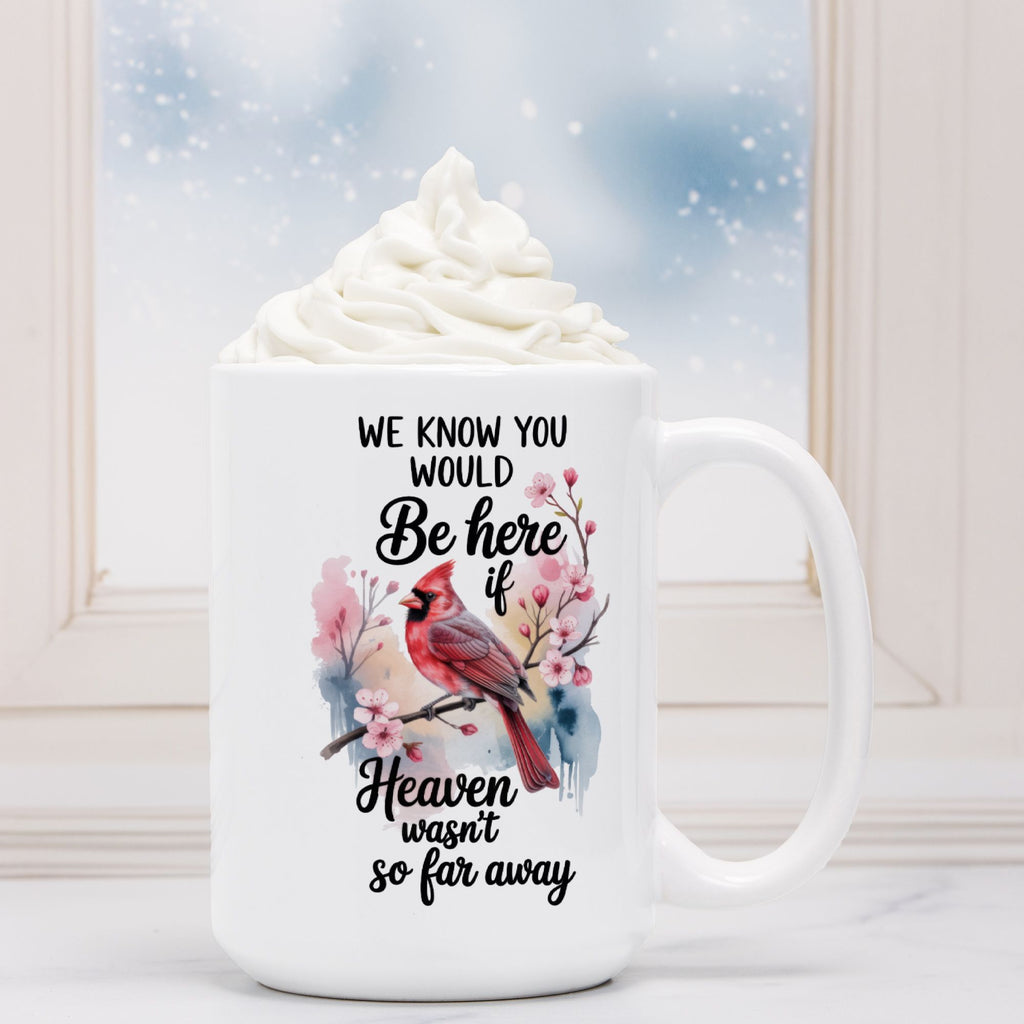 White mug with a cardinal design and text on a snowy background