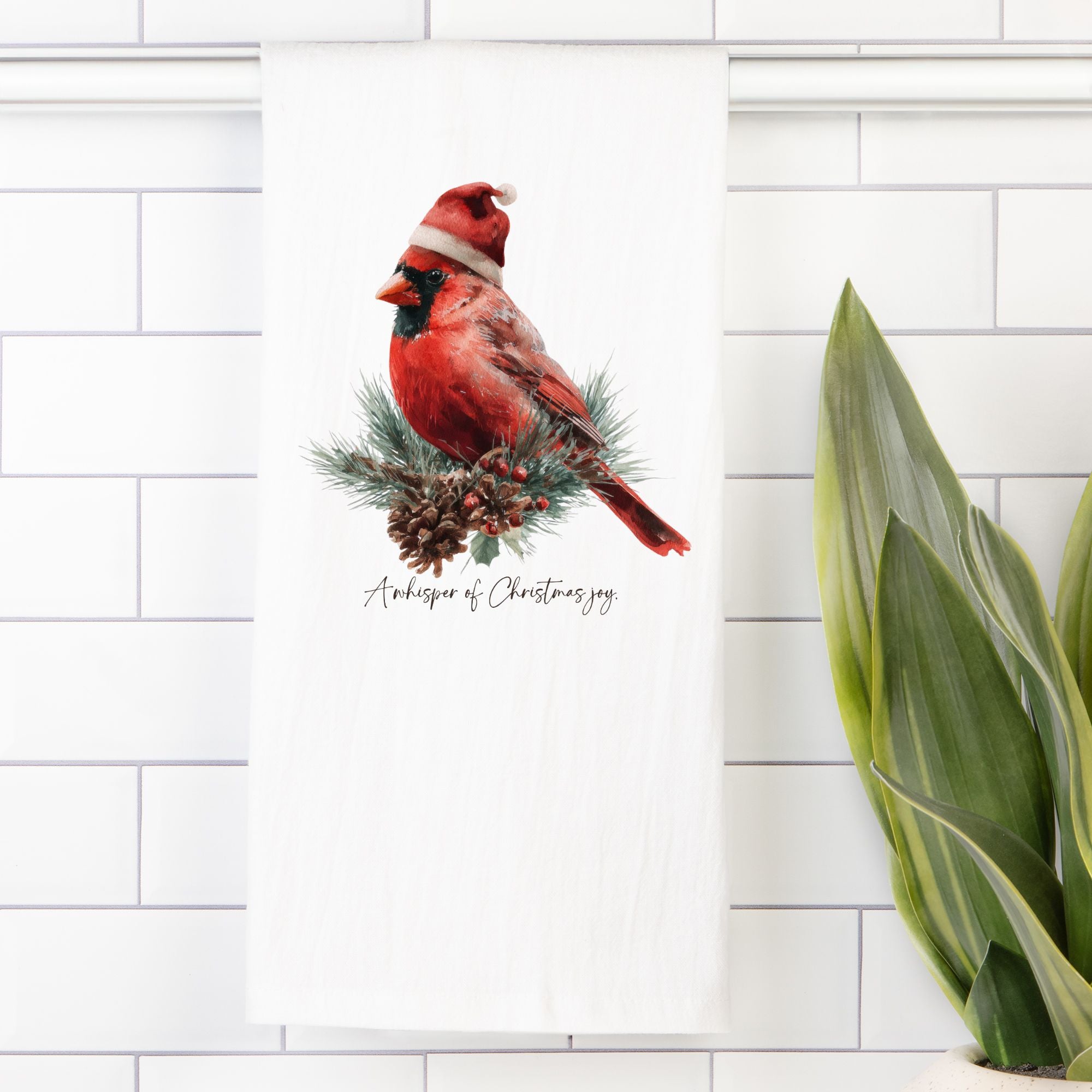 Cardinal bird with a pine cone on a white background with a plant on the side.