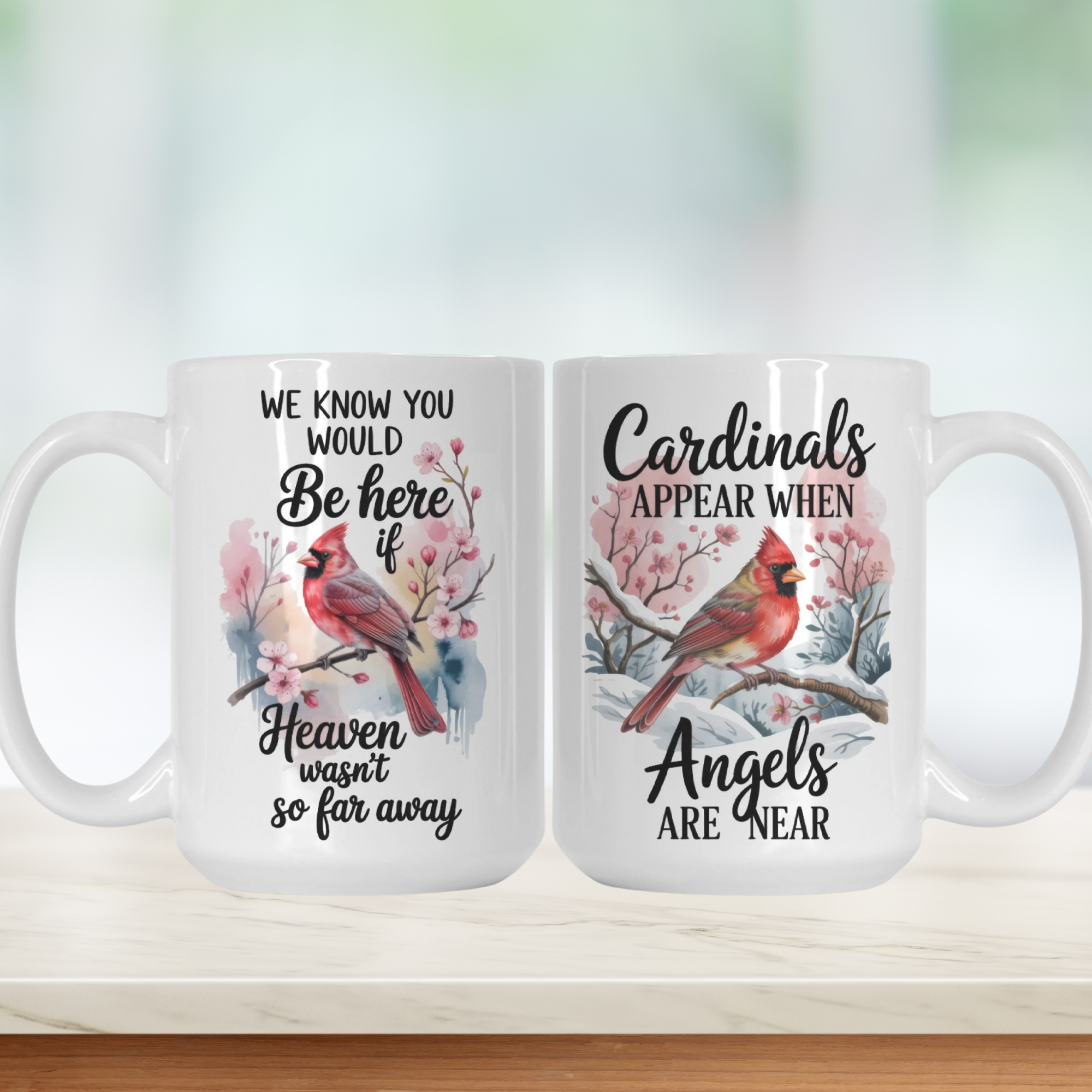 Two white mugs with cardinal designs and text on a light background