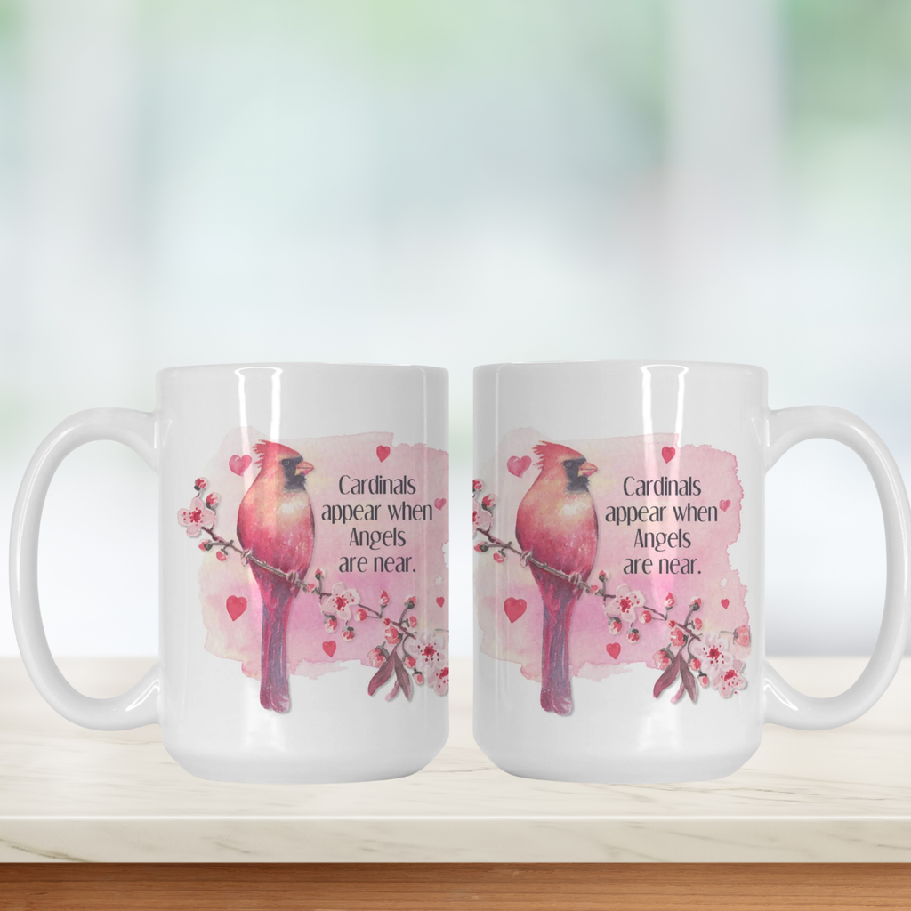 Two white mugs with pink cardinal design and text on a light background