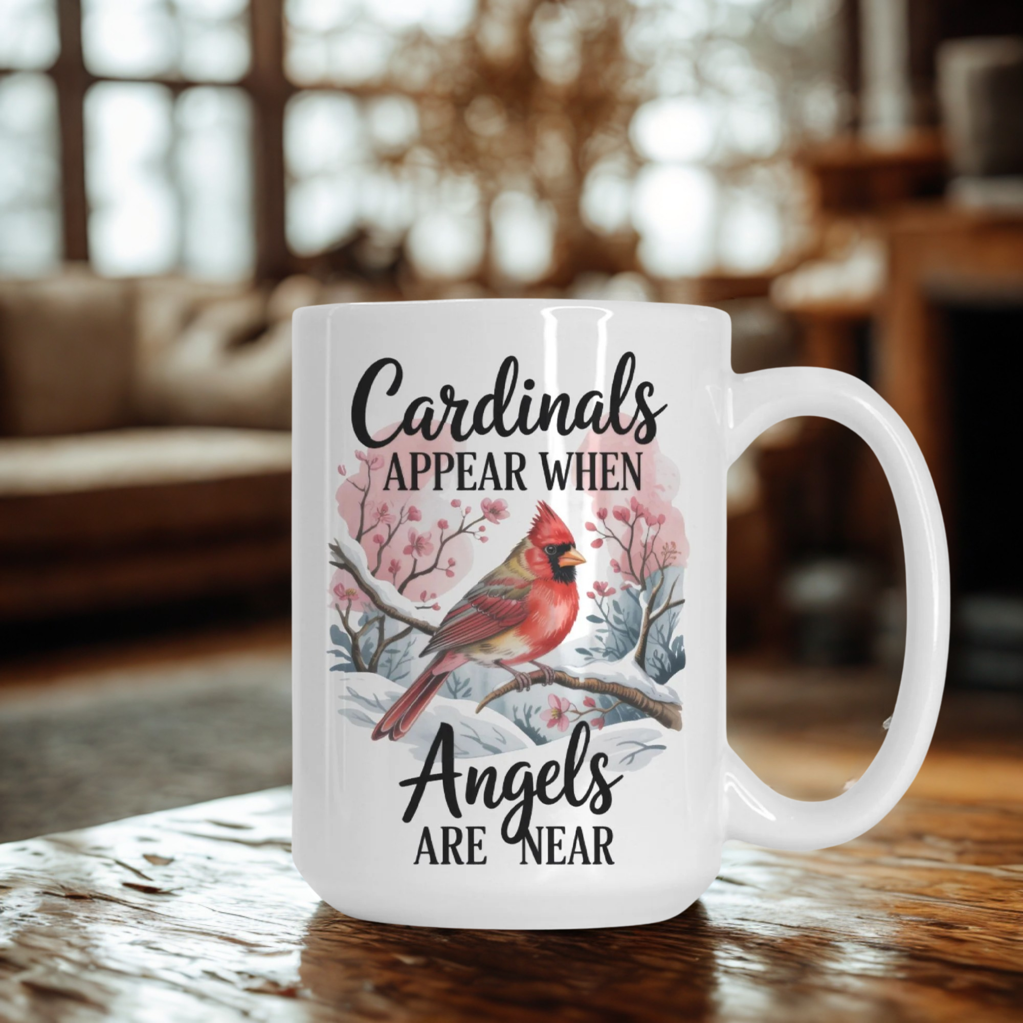 White mug with a cardinal design and text on a wooden table.