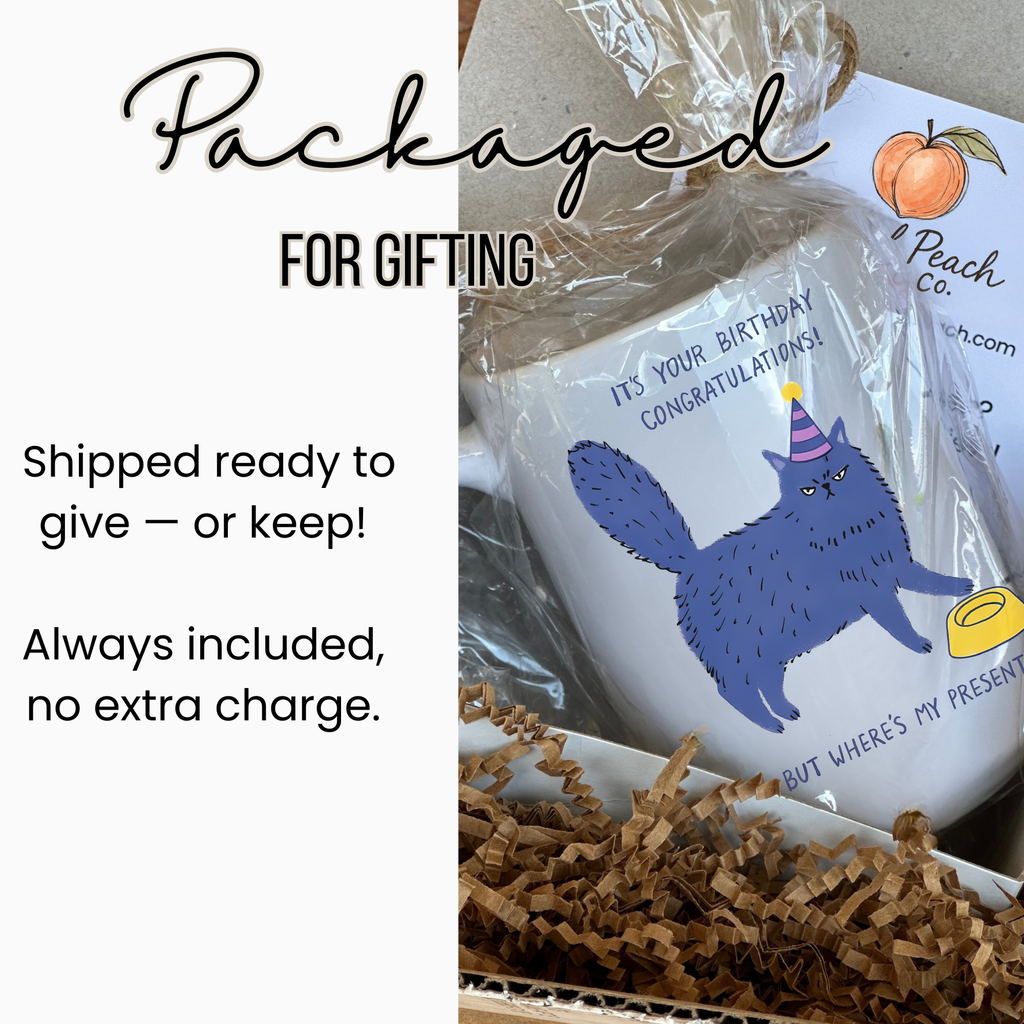 White mug with a blue cat illustration in a gift-wrapped box