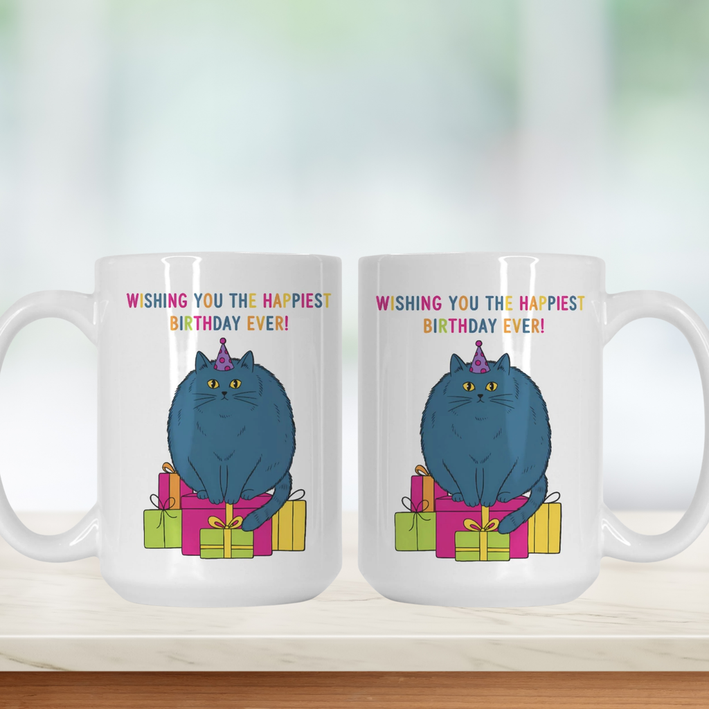 Two white mugs with a blue cat design and birthday text ' Wishing You The Happiest Birthday Ever' on a white background