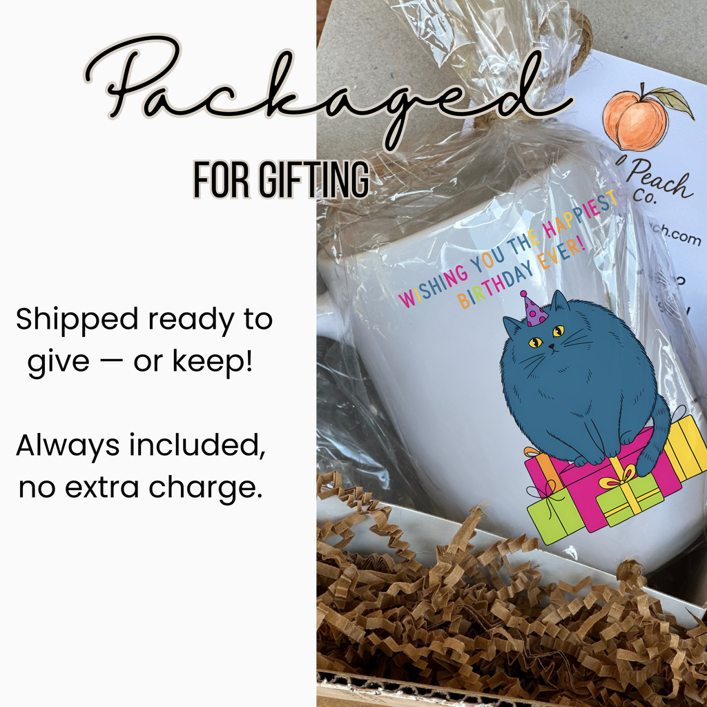 Gift-wrapped mug with a cat design and text 'Wishing You The Happiest Birthday Ever' on a white background.