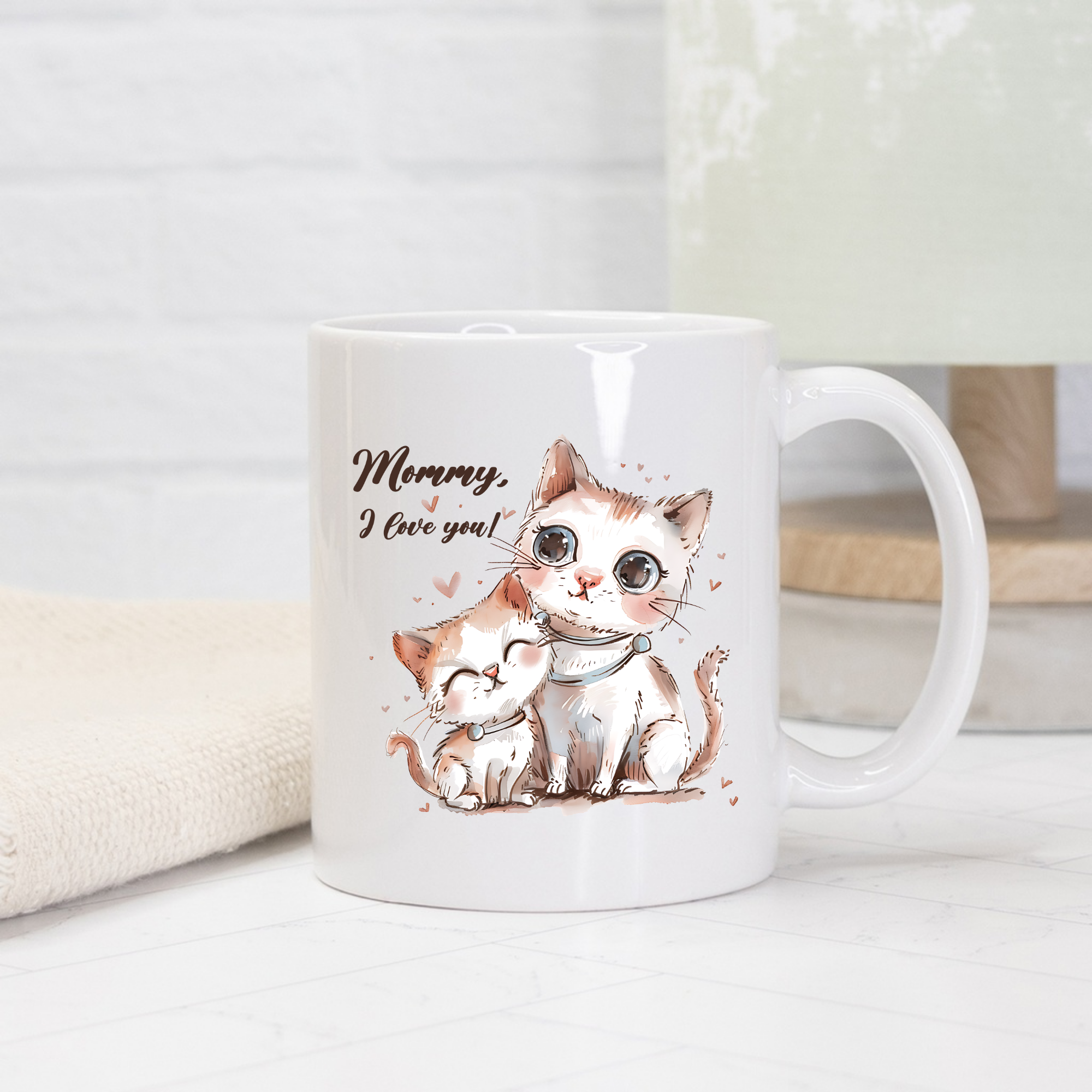 White mug with a cat illustration and 'Mommy, I love you!' text on a light background